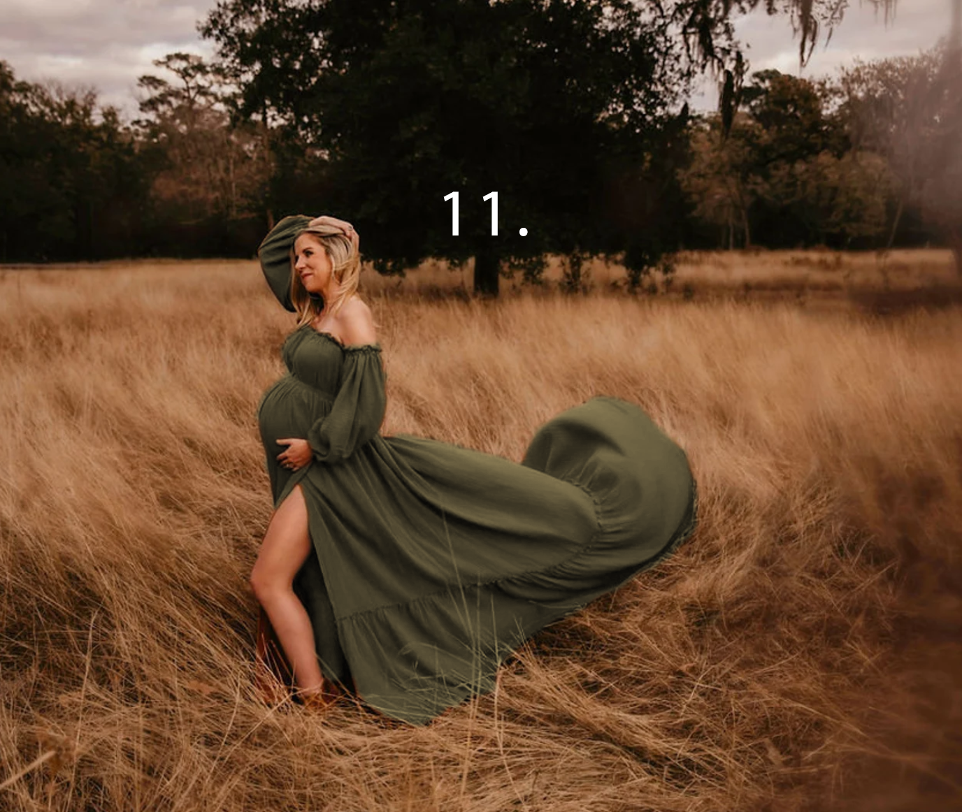 A person in a flowing olive green dress twirls gracefully in a golden autumn field at sunset.