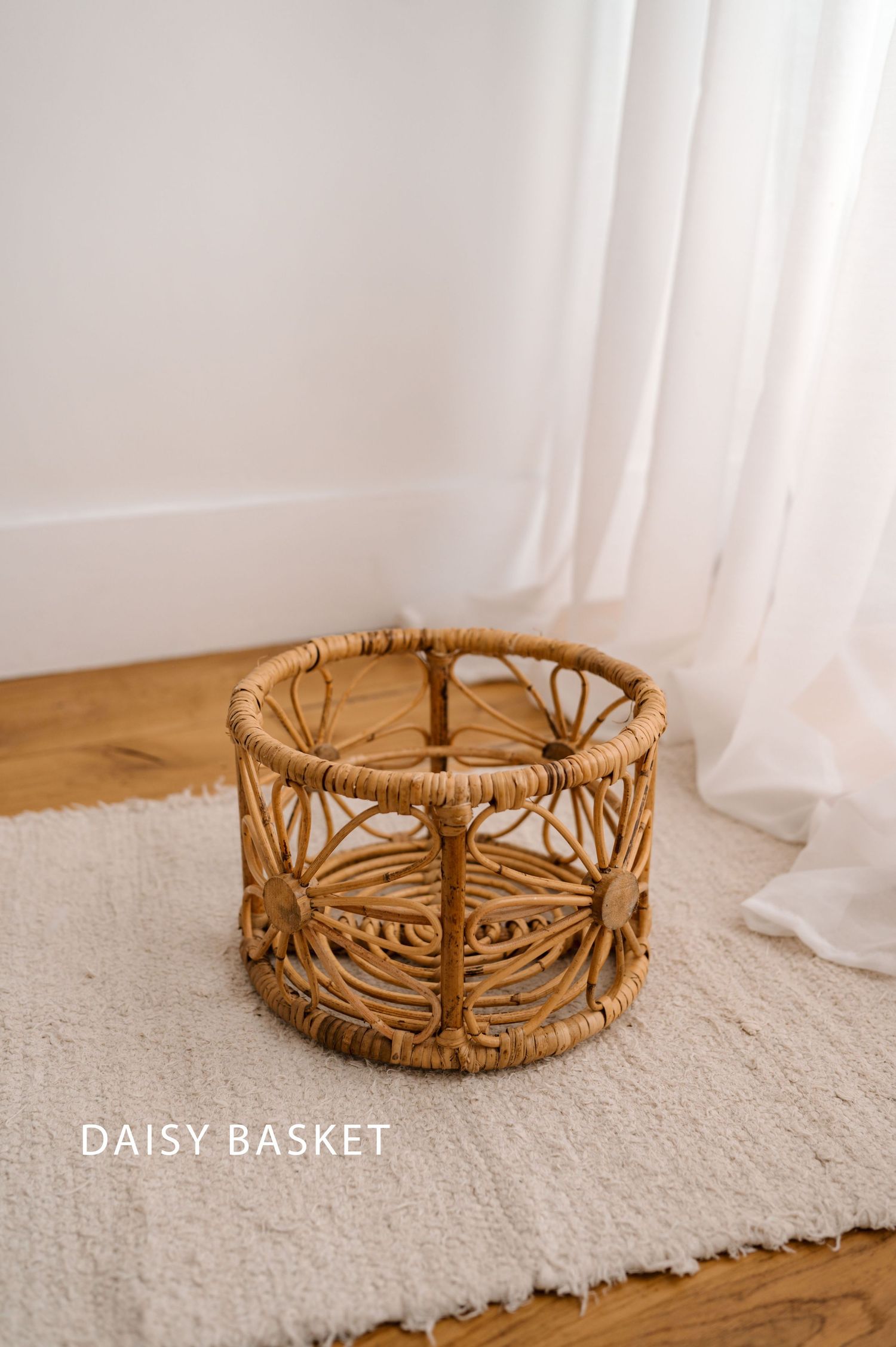Handwoven rattan basket with daisy flower design shown in multiple angles on a white carpet against light backdrop.