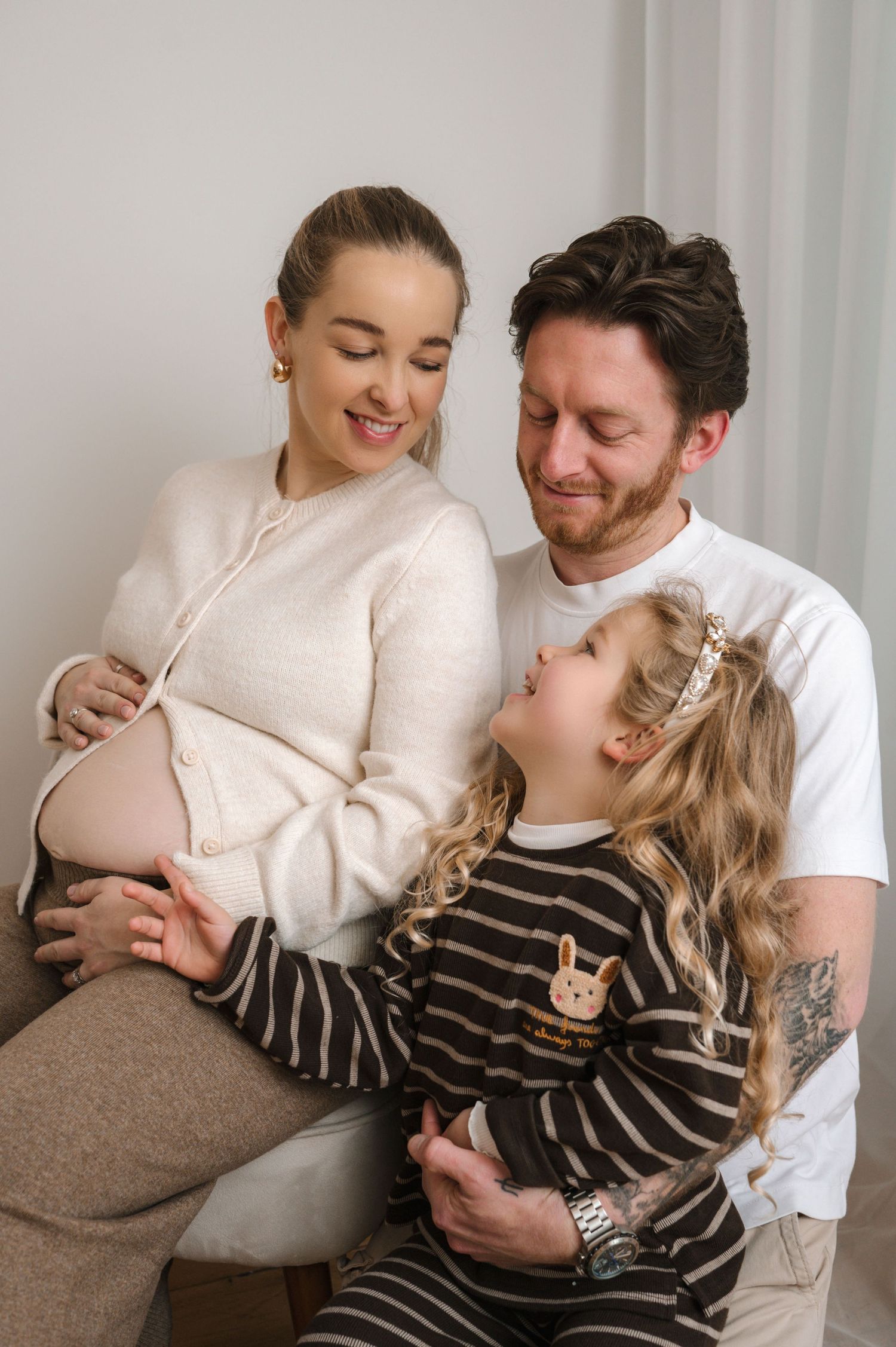 A loving couple shares tender moments in a series of intimate portraits against a light background.