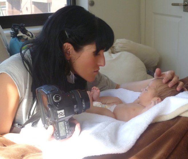 Photographer capturing closeup details during newborn photo session.