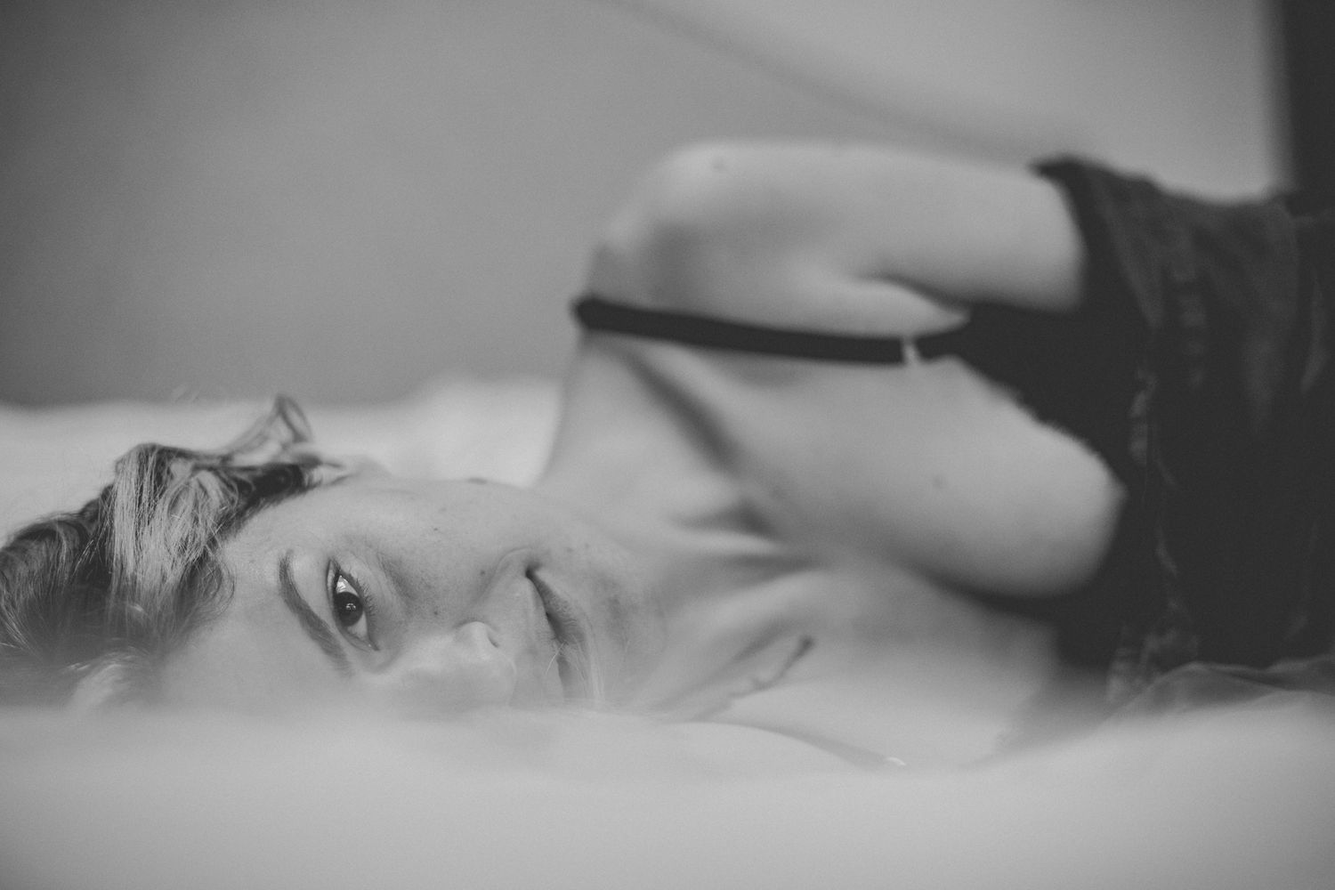 Black and white intimate portrait with shallow depth of field creating dreamy mood.