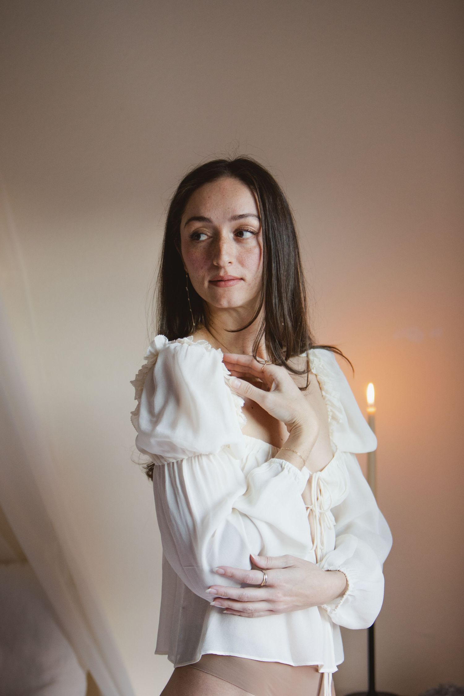 A series of photos showing a white peasant blouse with puff sleeves against a neutral background.