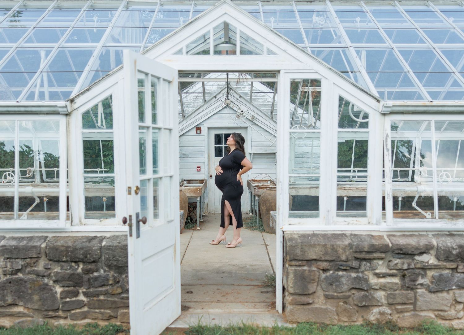 A white-framed greenhouse conservatory structure with glass panels and stone foundation shown from multiple angles.