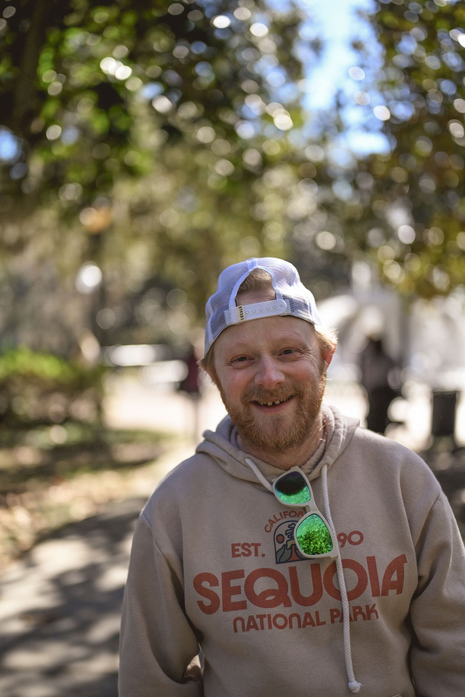 Three sequential photos show someone wearing a light-colored Sequoia National Park hoodie in an outdoor setting.