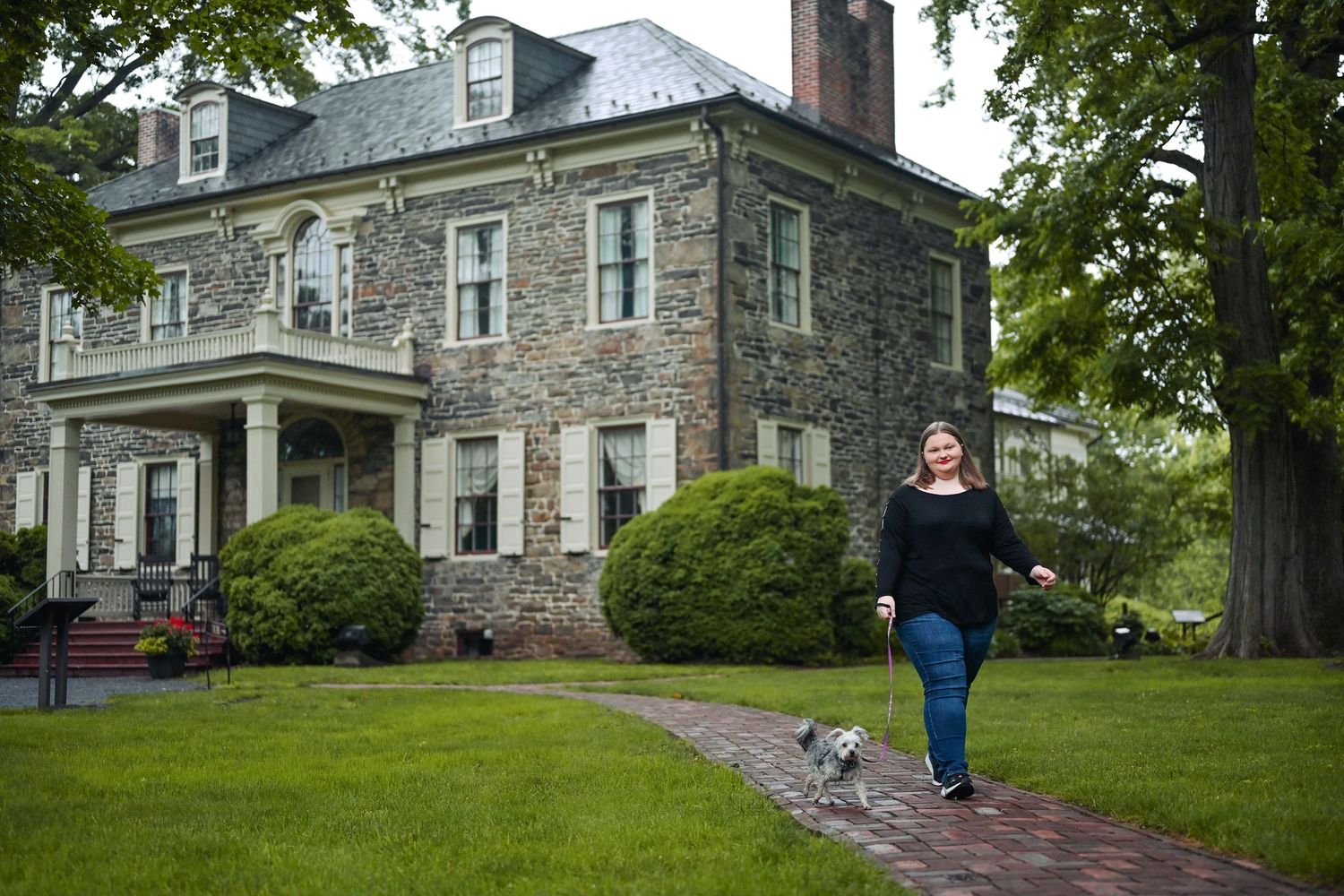 A series of four connected images showing an exterior view of a historic stone mansion with green lawns and trees.