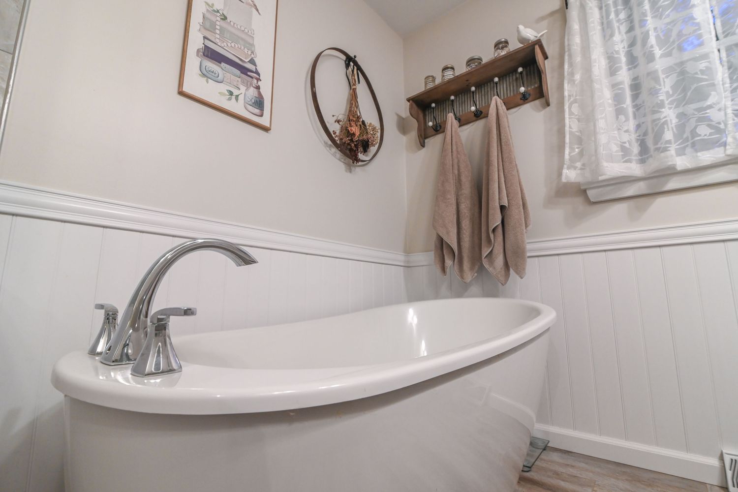 Modern bathroom interior with white bathtub, chrome fixtures, and neutral beige walls showing multiple angles.