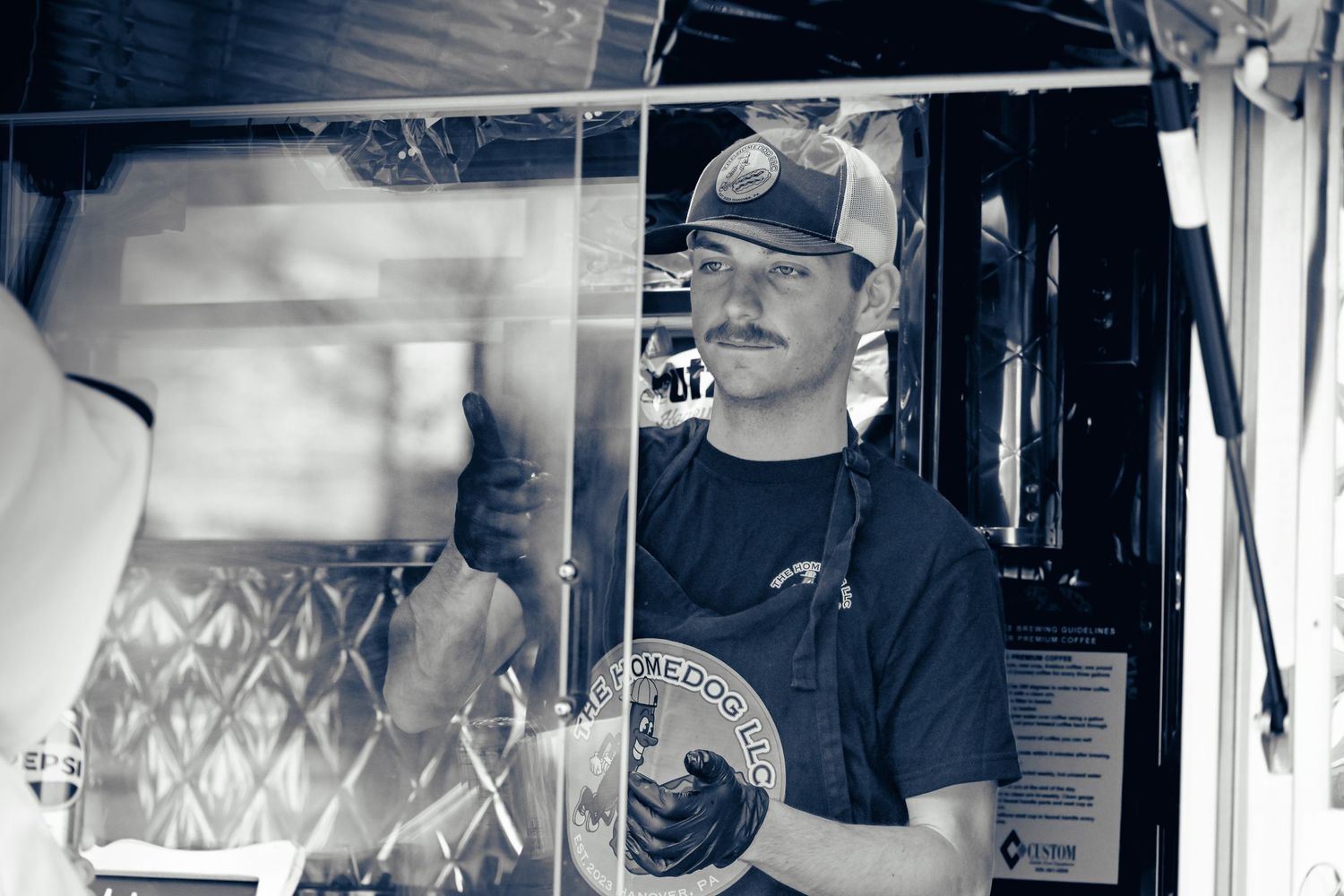 A person serves hotdogs