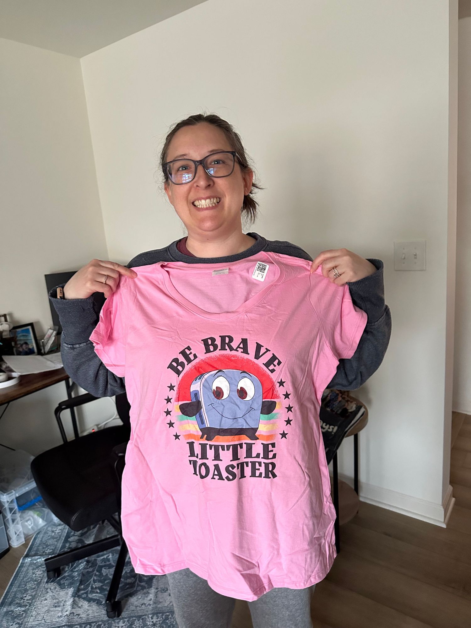 A series of photos showing a pink t-shirt with 'Be Brave Little Toaster' text and toaster design being displayed.