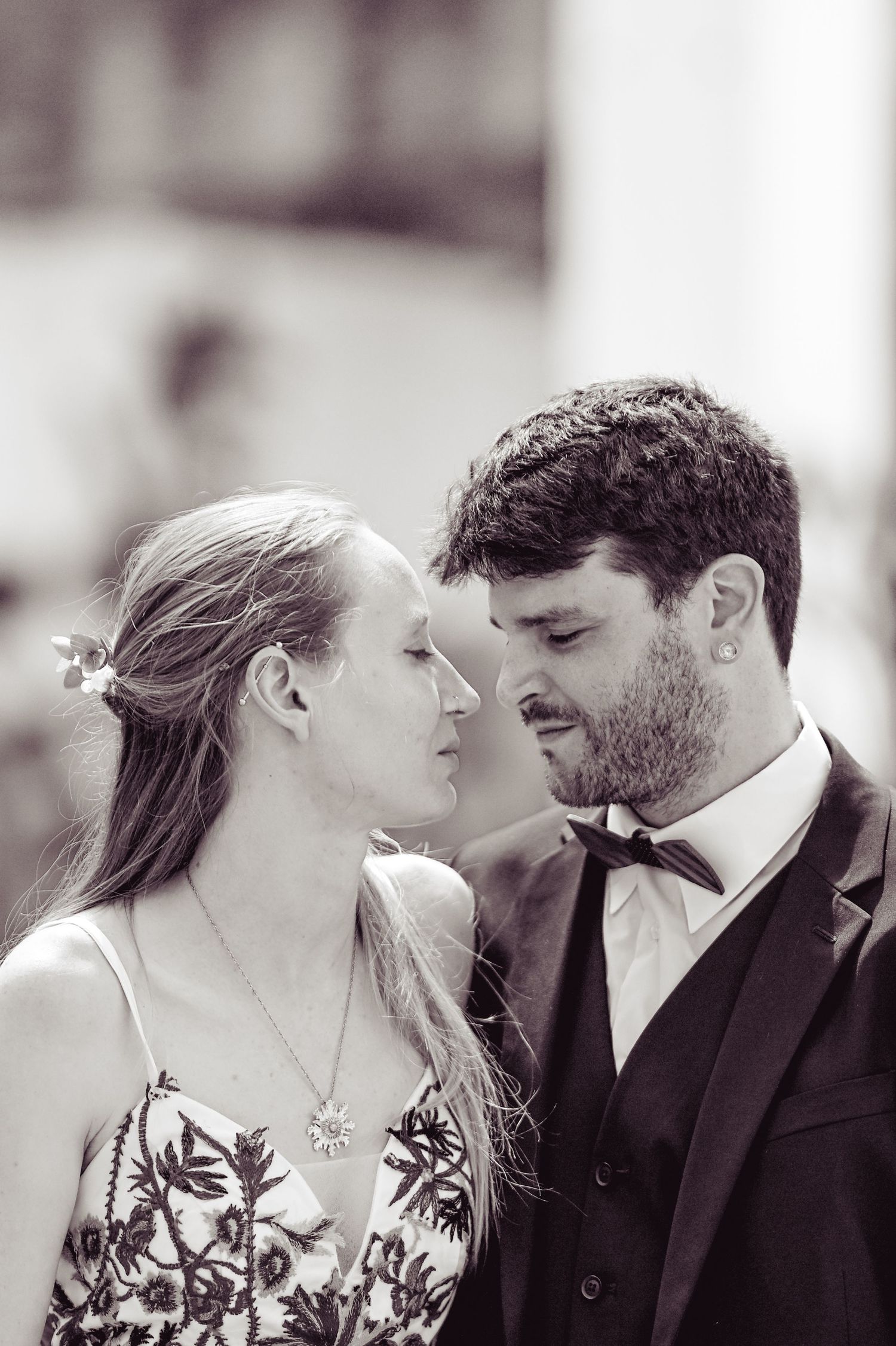 A romantic black and white photo series showing a couple sharing intimate moments in formal wedding attire.