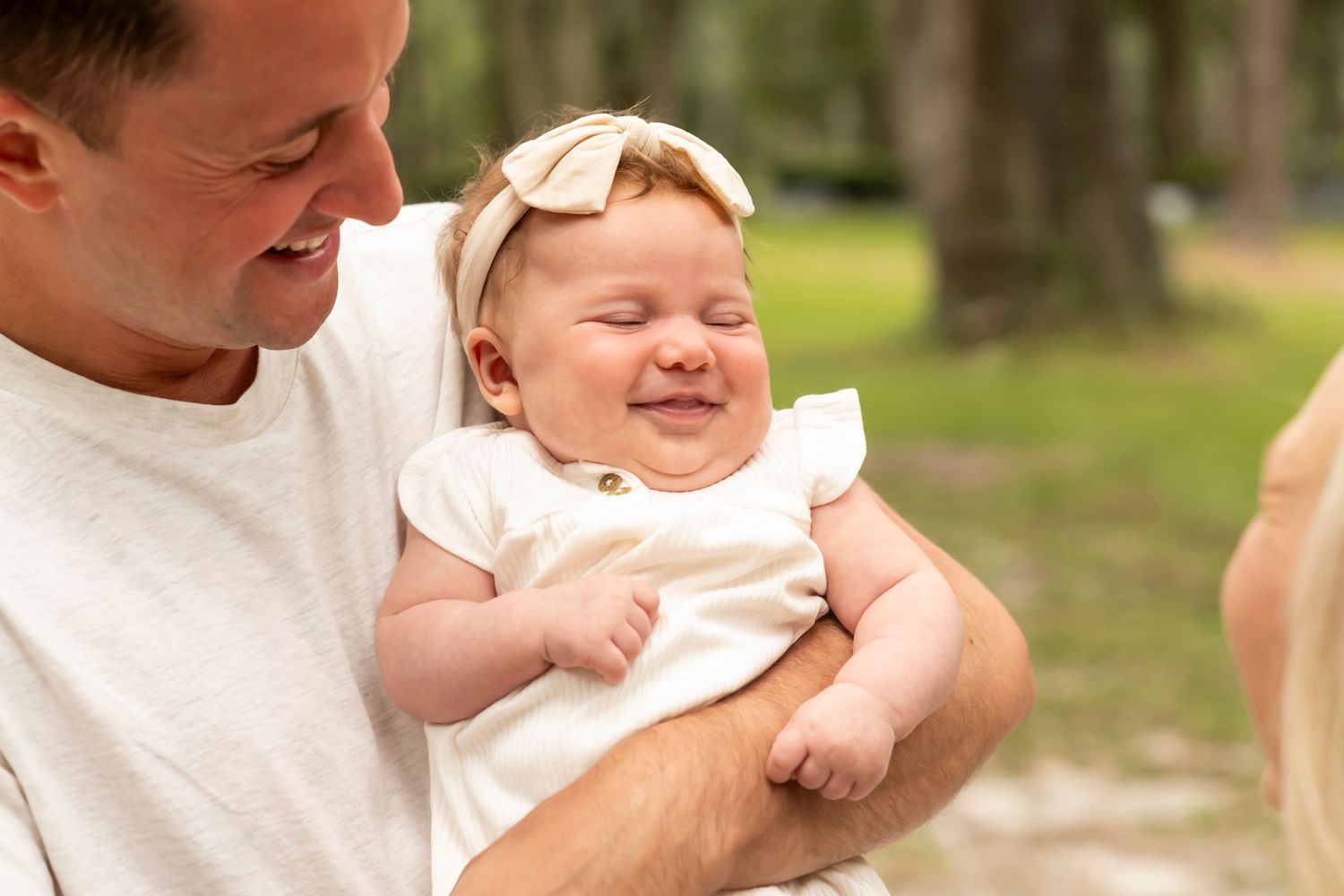 A family enjoying intimate moments together during an outdoor photoshoot.