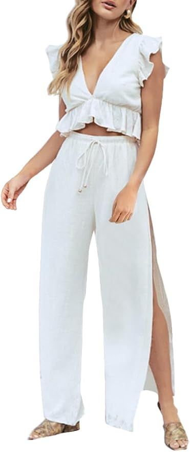 White two-piece summer outfit featuring a ruffled crop top and flowy side-slit pants with drawstring waist.