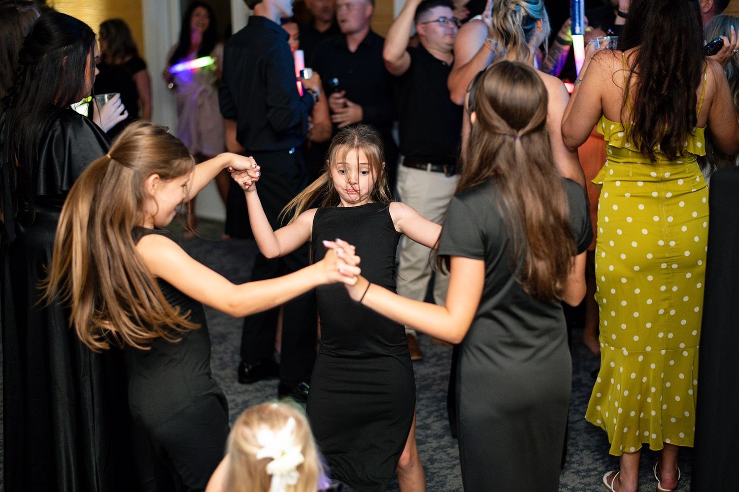 Wedding reception dance floor filled with guests enjoying the celebration.