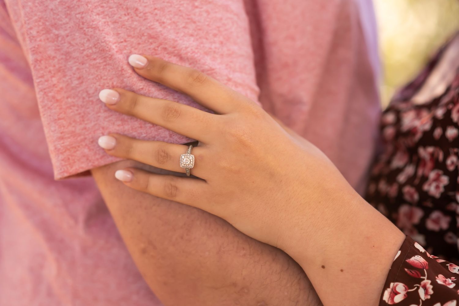 Close-up of fingers wearing engagement rings and wedding bands arranged in a sequence showing different angles.