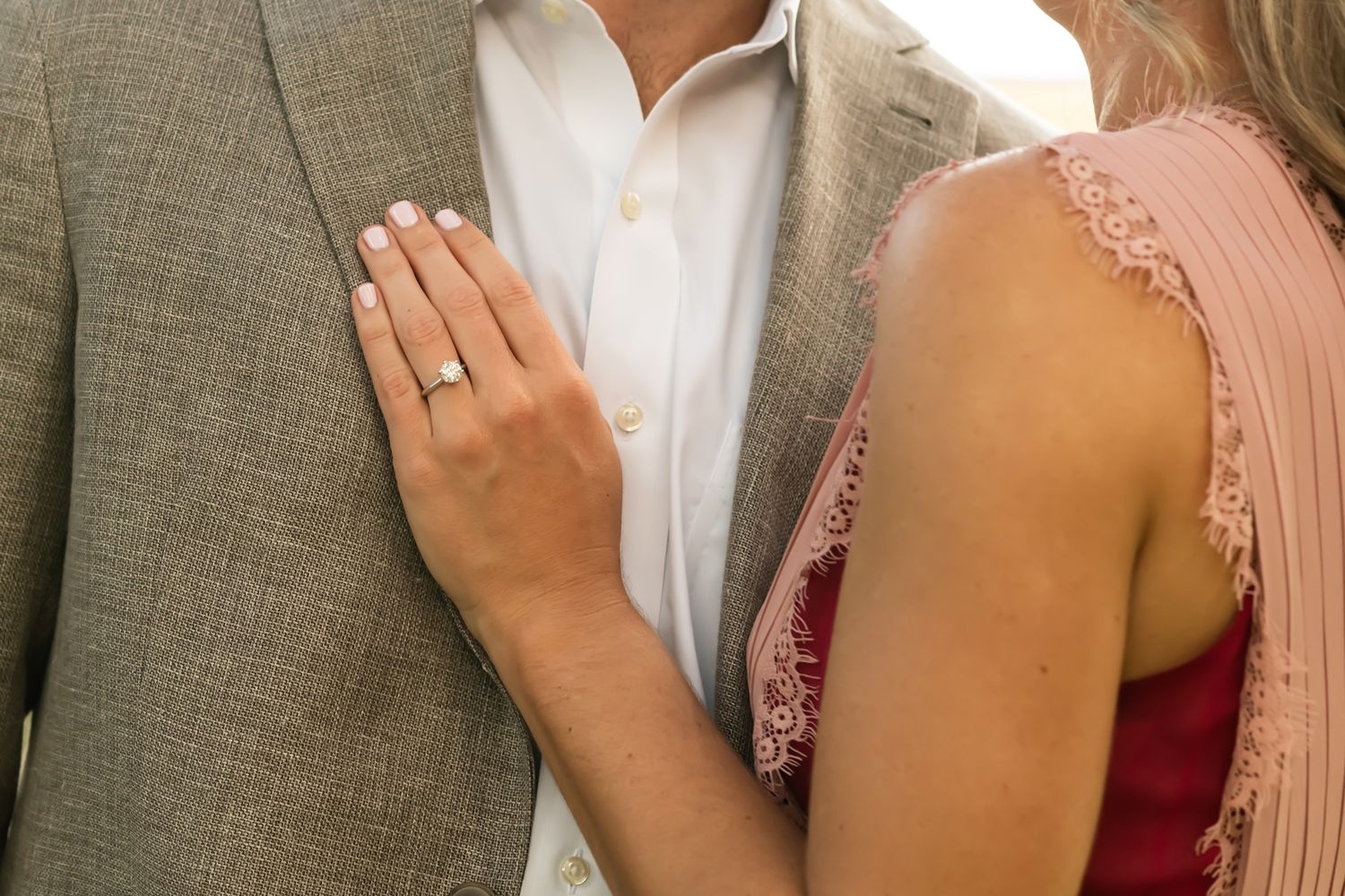 A series of photos showing someone adjusting a pink dress on another person during a formal occasion.