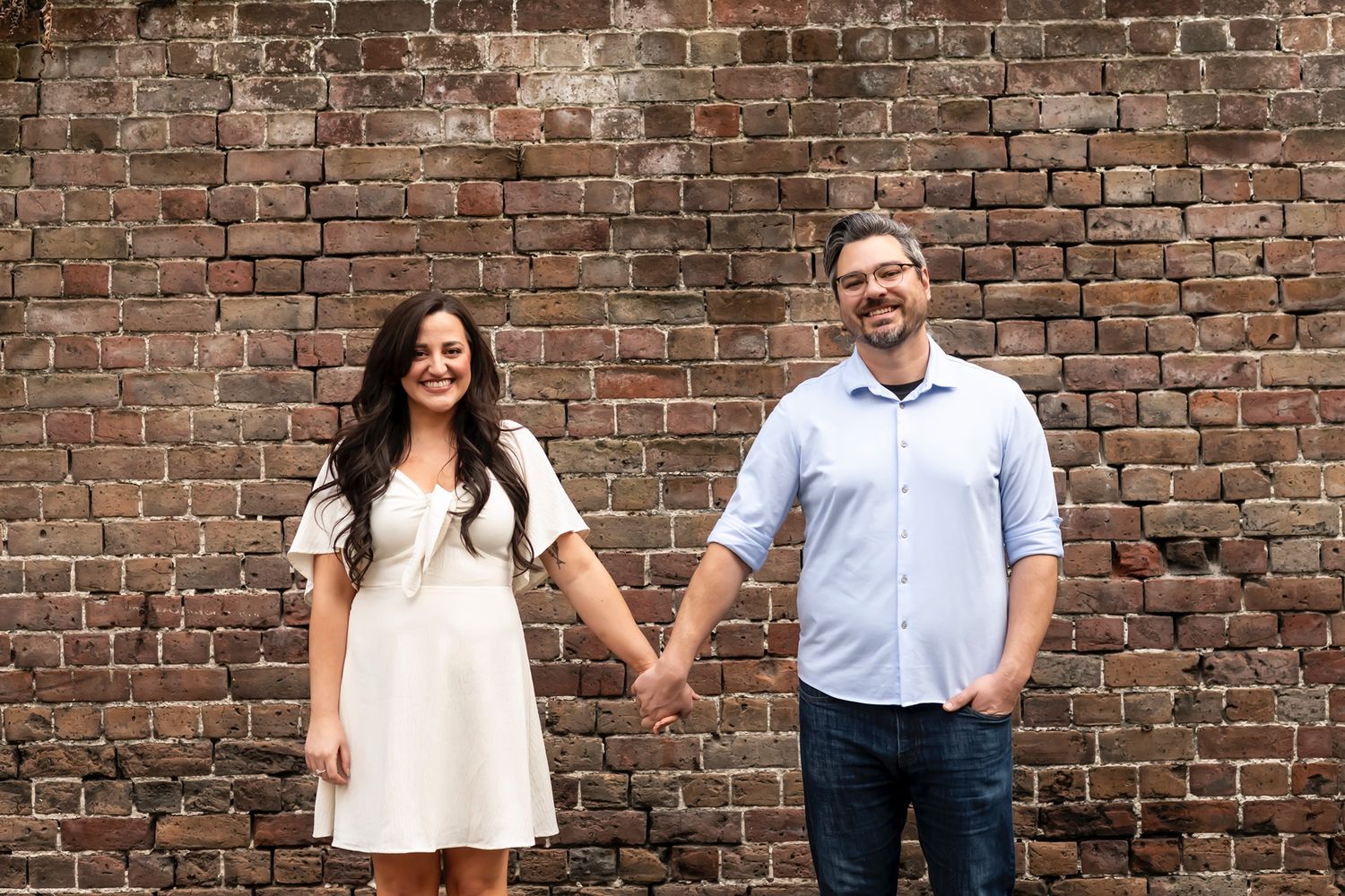 Six connected portrait photos against a rustic brick wall background showing people in casual attire.