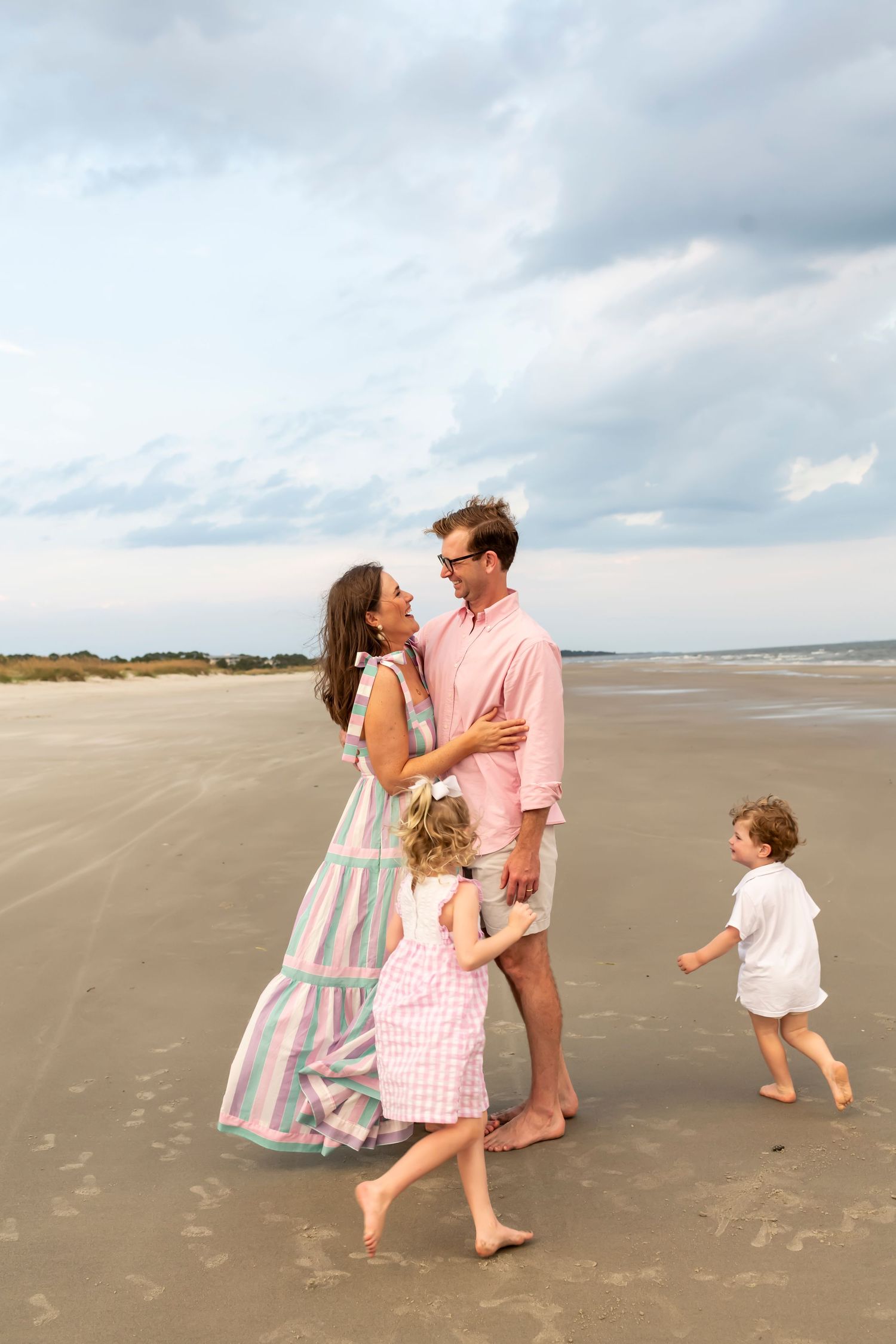 A family enjoys tender moments together on the beach on Hilton Head Island