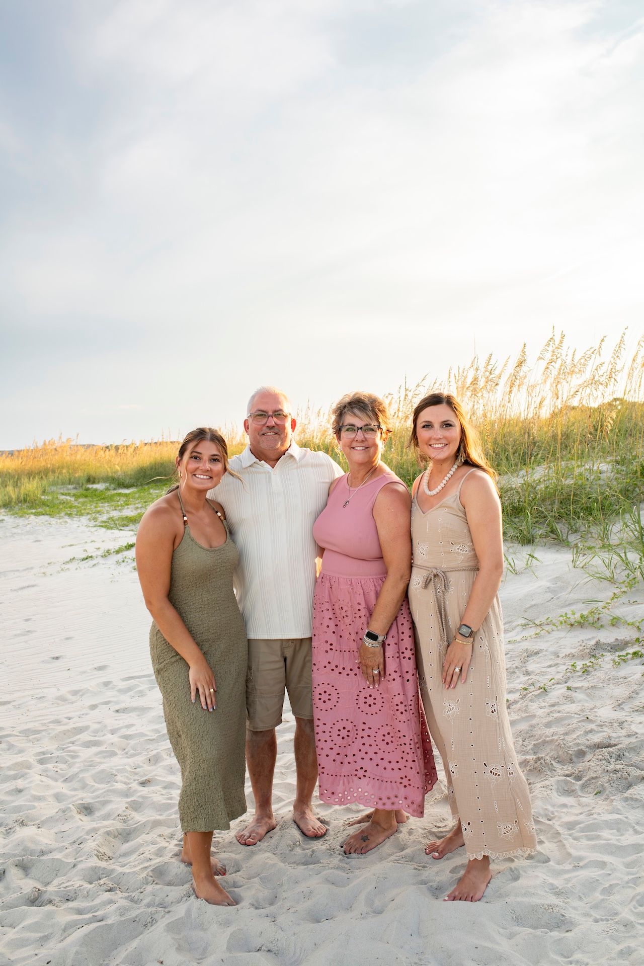 Parents and grown children posing for a family portrait on the beach on Hilton Head Island in South Carolina.