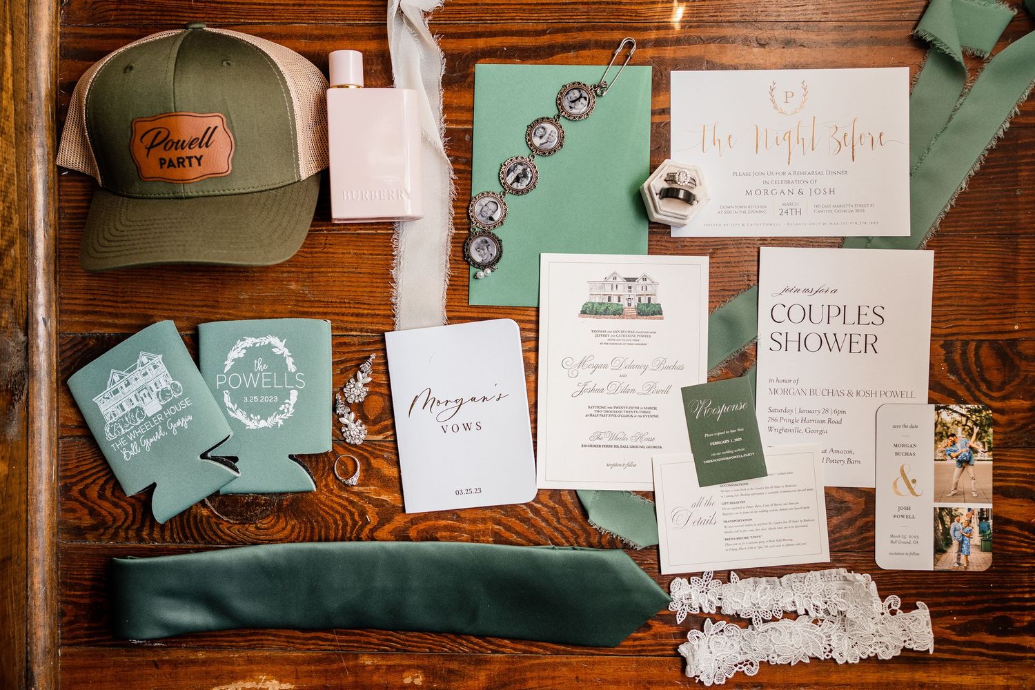 Wedding event invitations and branding materials arranged on a wooden surface with sage green and white color scheme details.