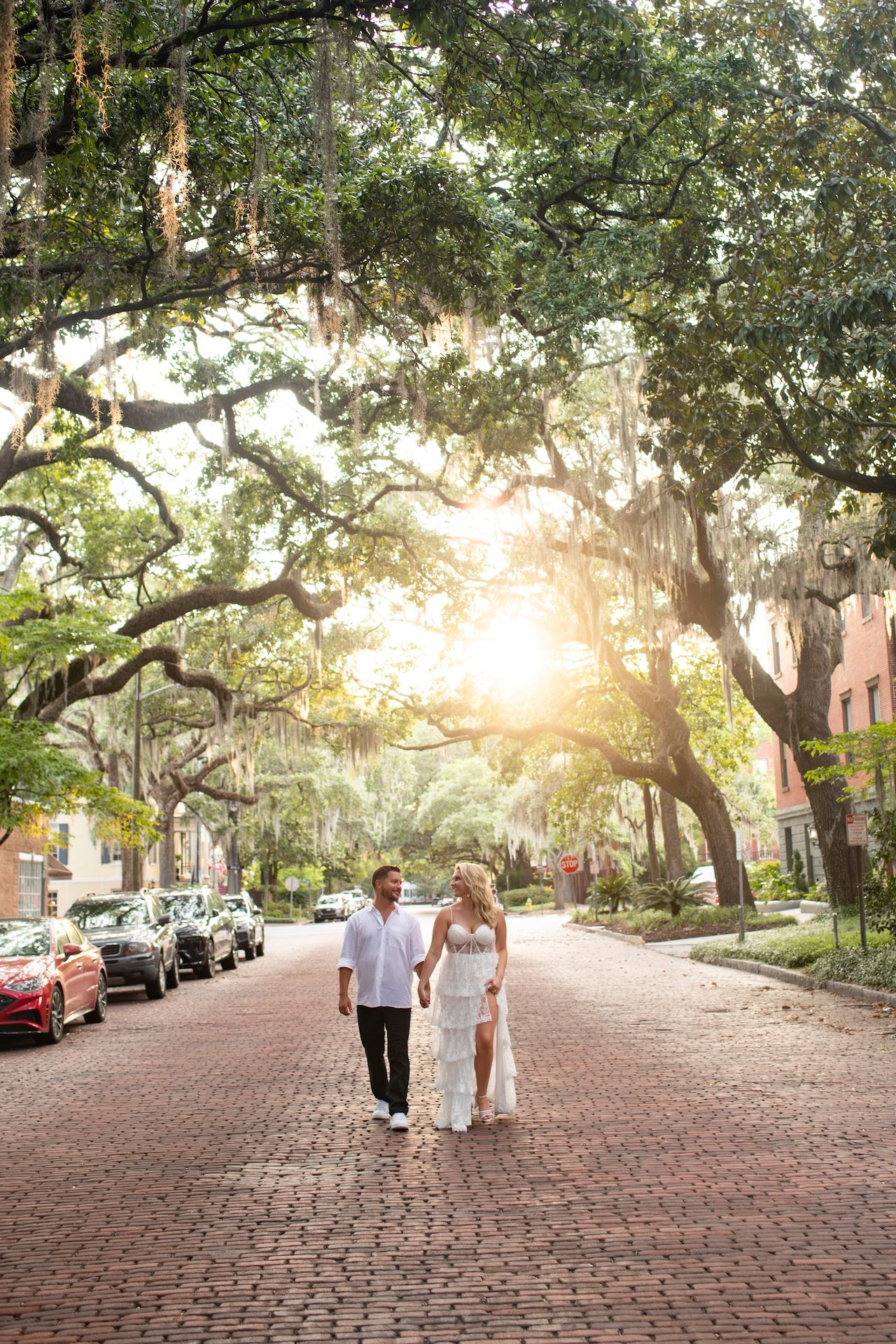 Couple walking on Jones Street in Savannah engagement session.