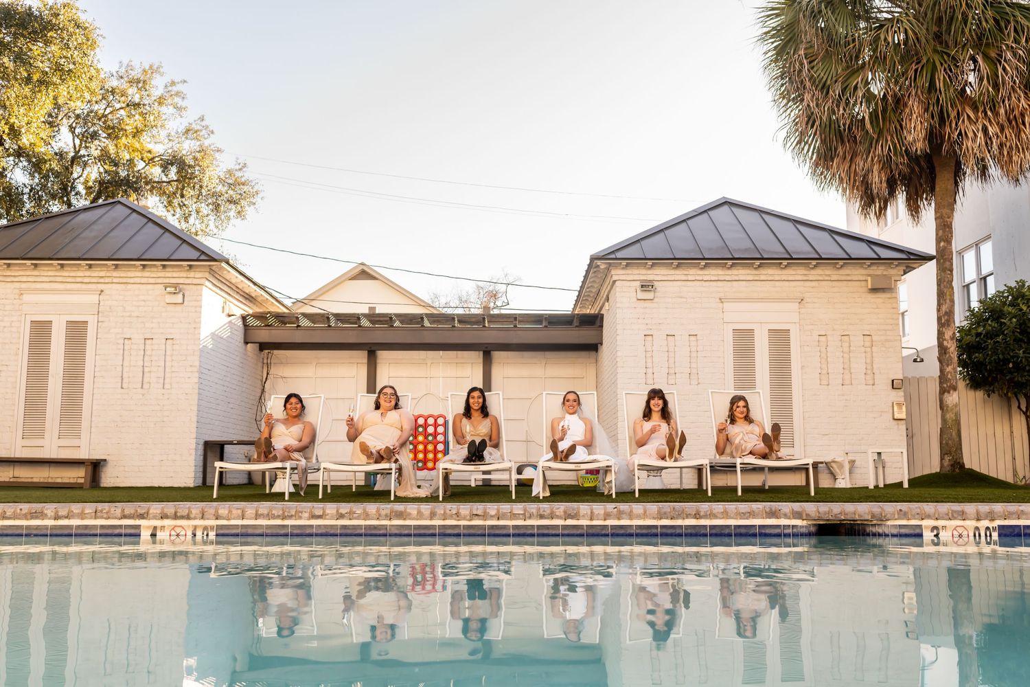 Bridal party lounging at the pool for a Kimpton Brice Hotel Wedding in Savannah, Georgia.