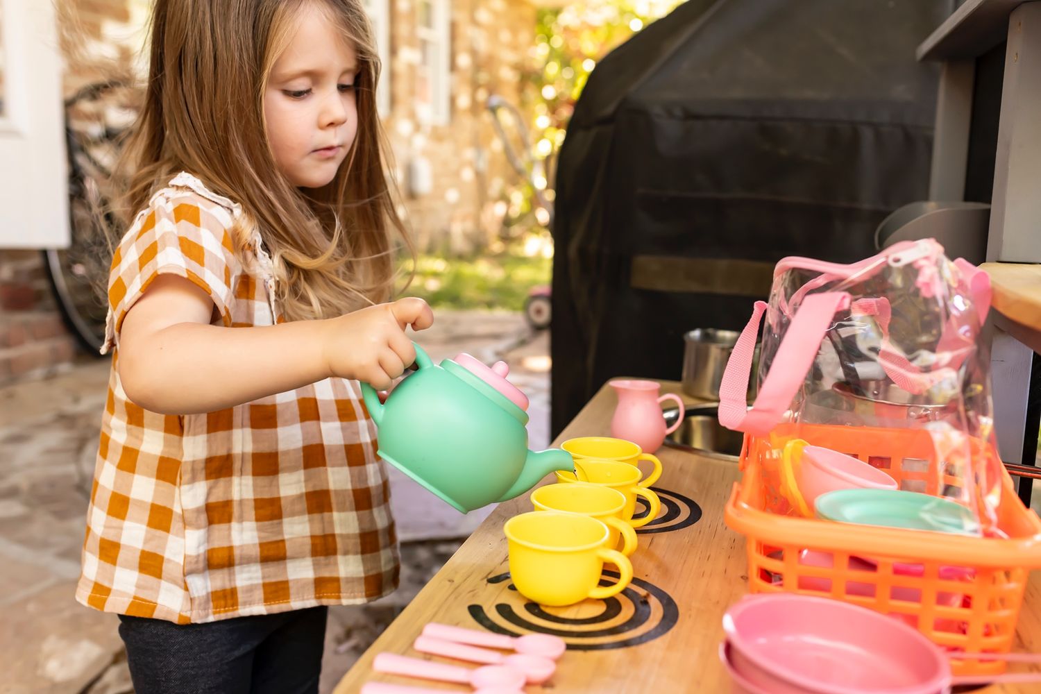 A colorful hands-on sensory activity with curved wire tracks and bright plastic spheres being manipulated.