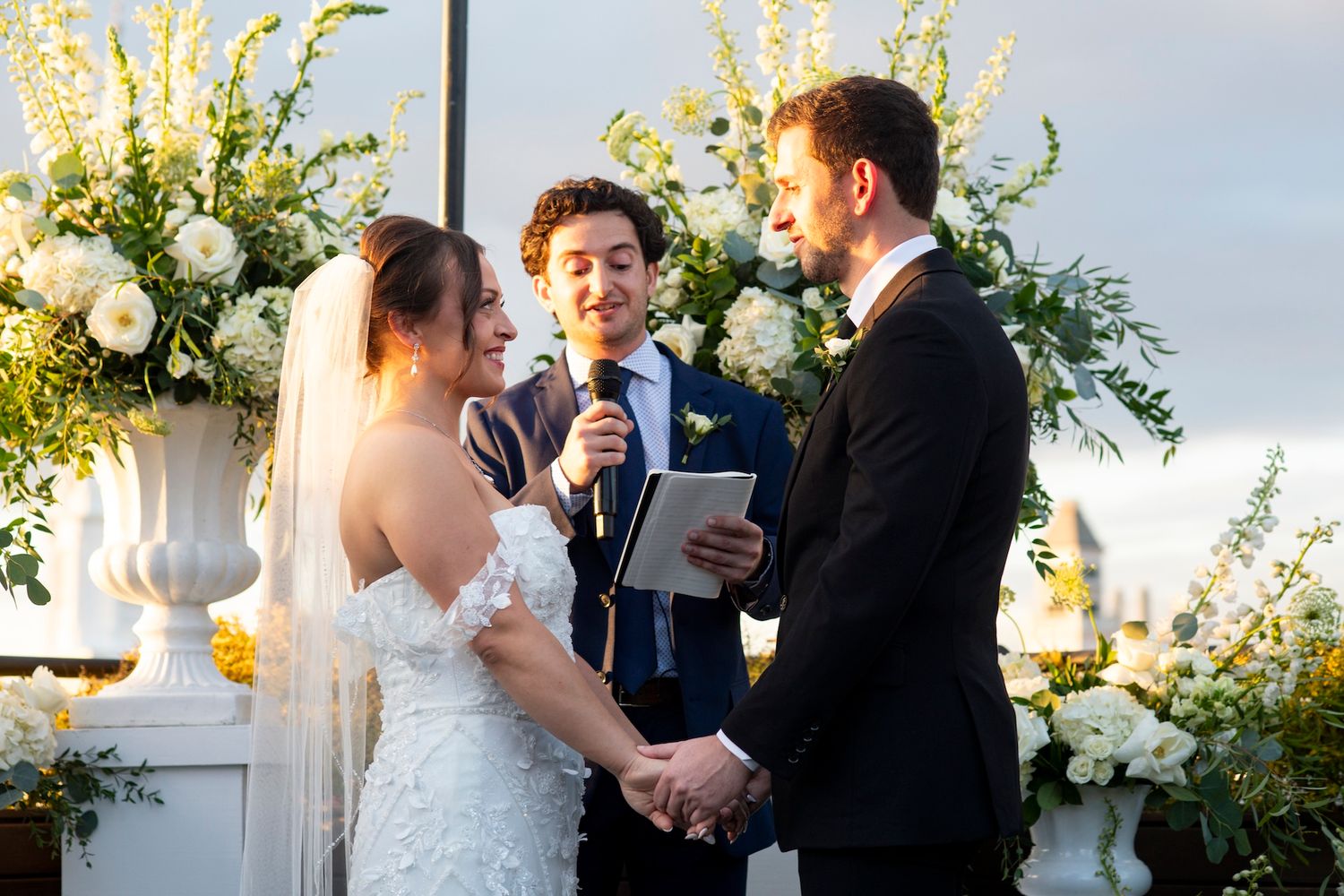 A romantic wedding ceremony with a couple sharing their first dance surrounded by floral decorations and candlelight.
