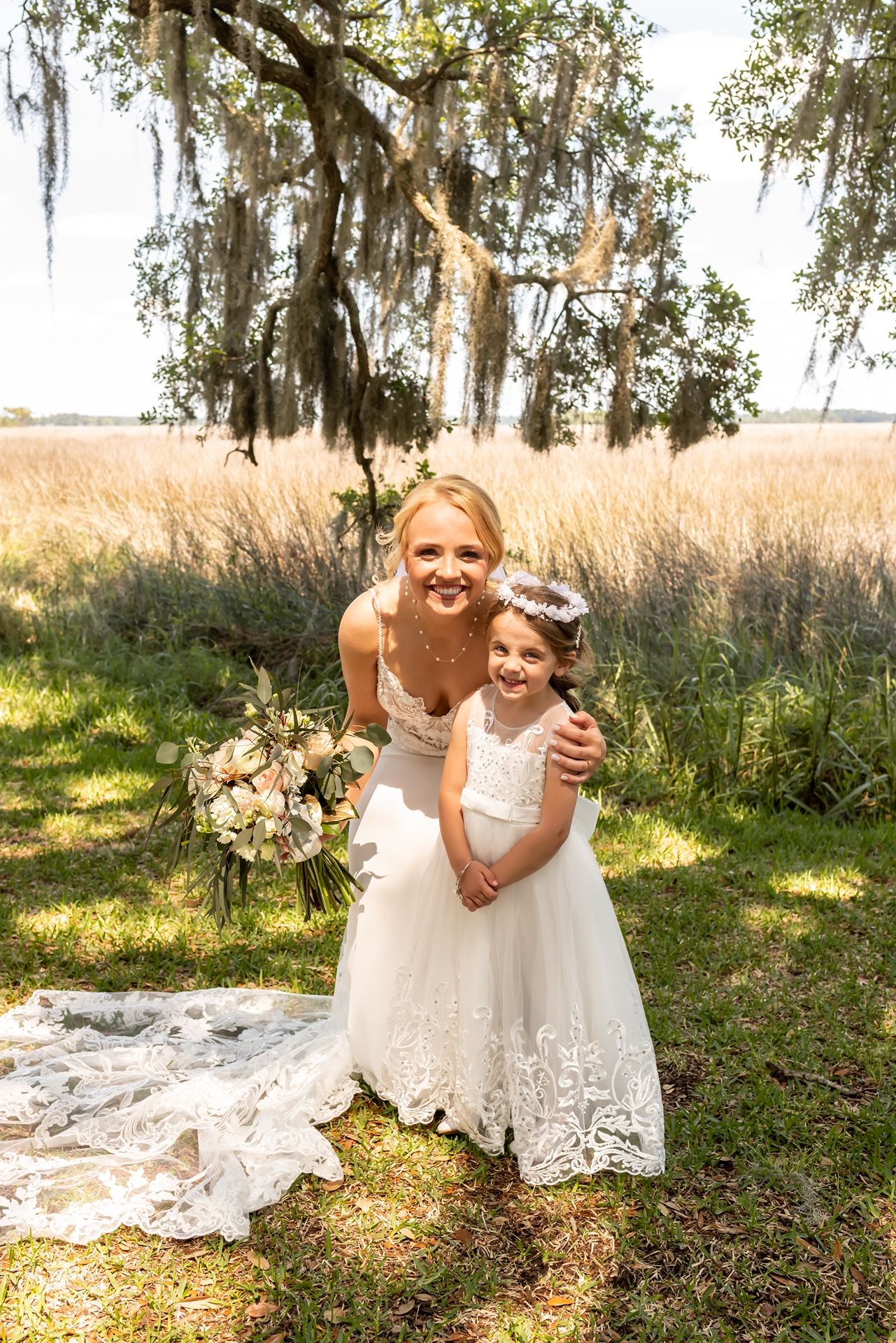 Wedding images show intimate moments outdoors with white dresses against a backdrop of Spanish moss and sunlit grass.