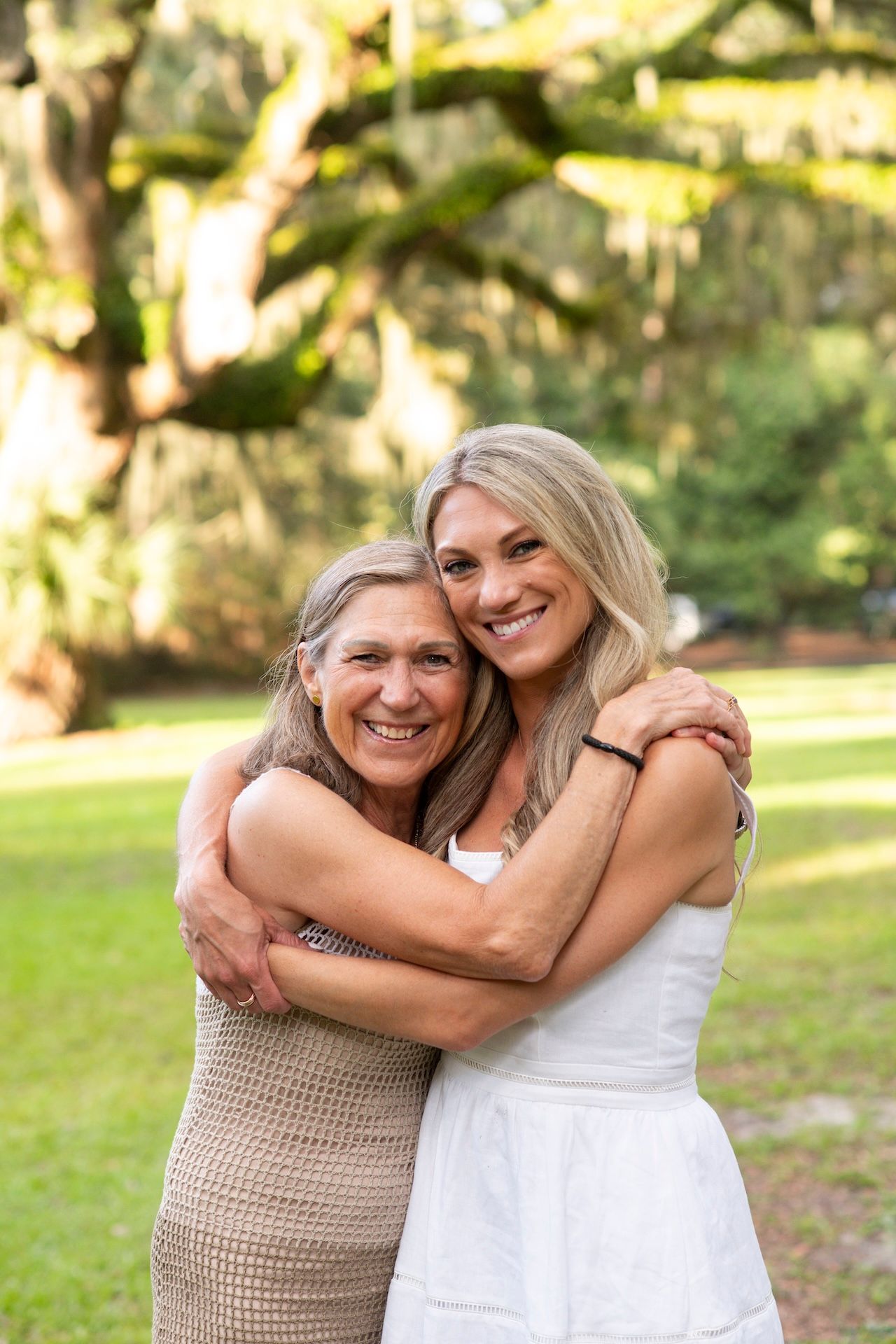 Mother and grown daughter hugging and smiling for a portrait on Hilton Head.