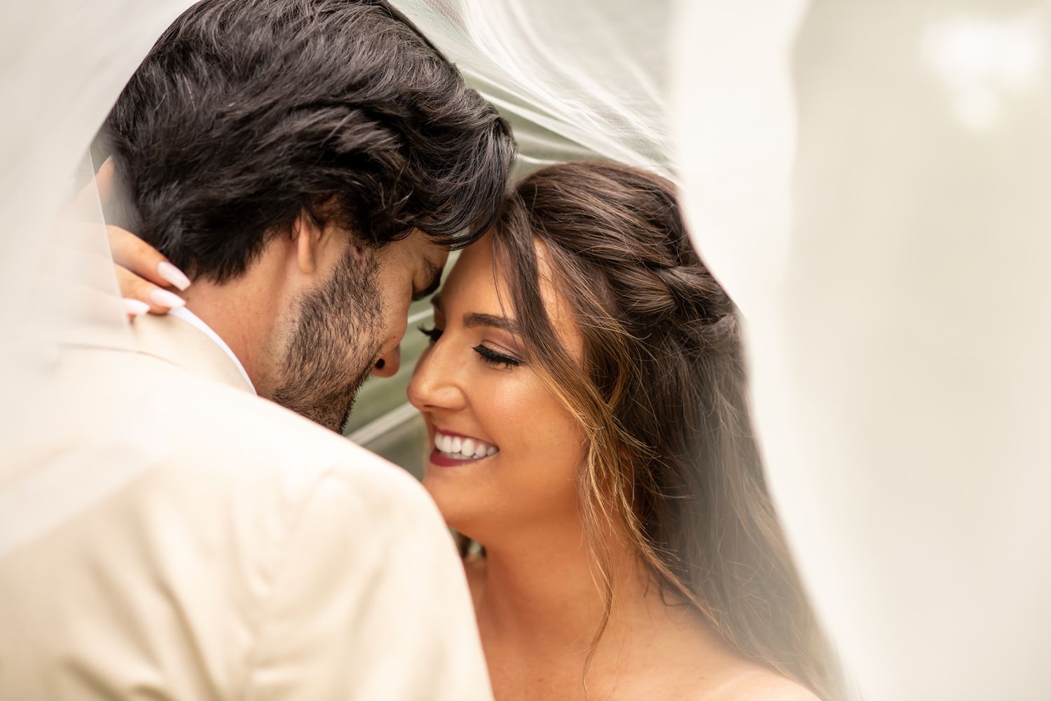 A joyful bride and groom share an intimate moment during their wedding ceremony.