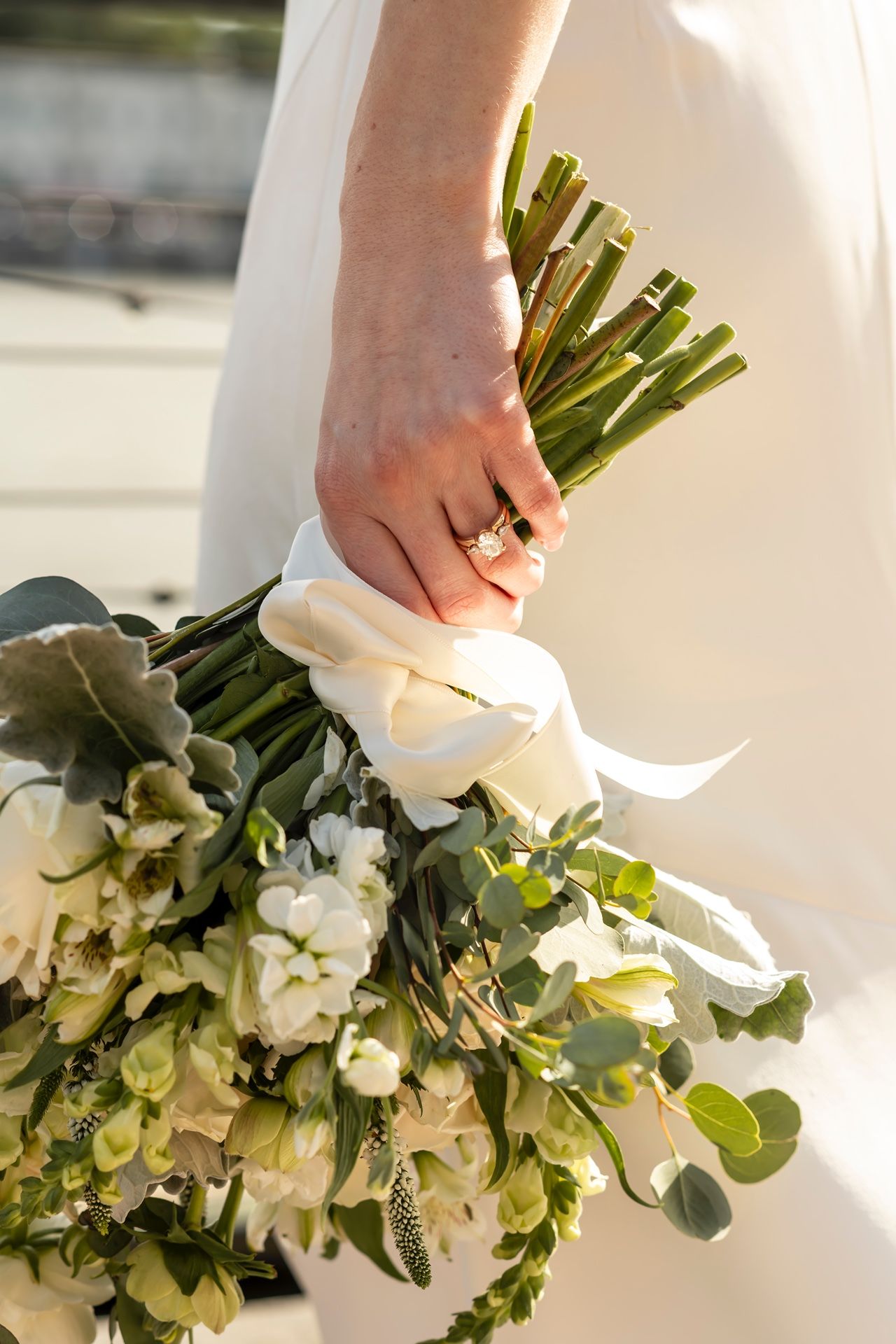 A series of white and green wedding bouquet details showing florals and eucalyptus against a light background.