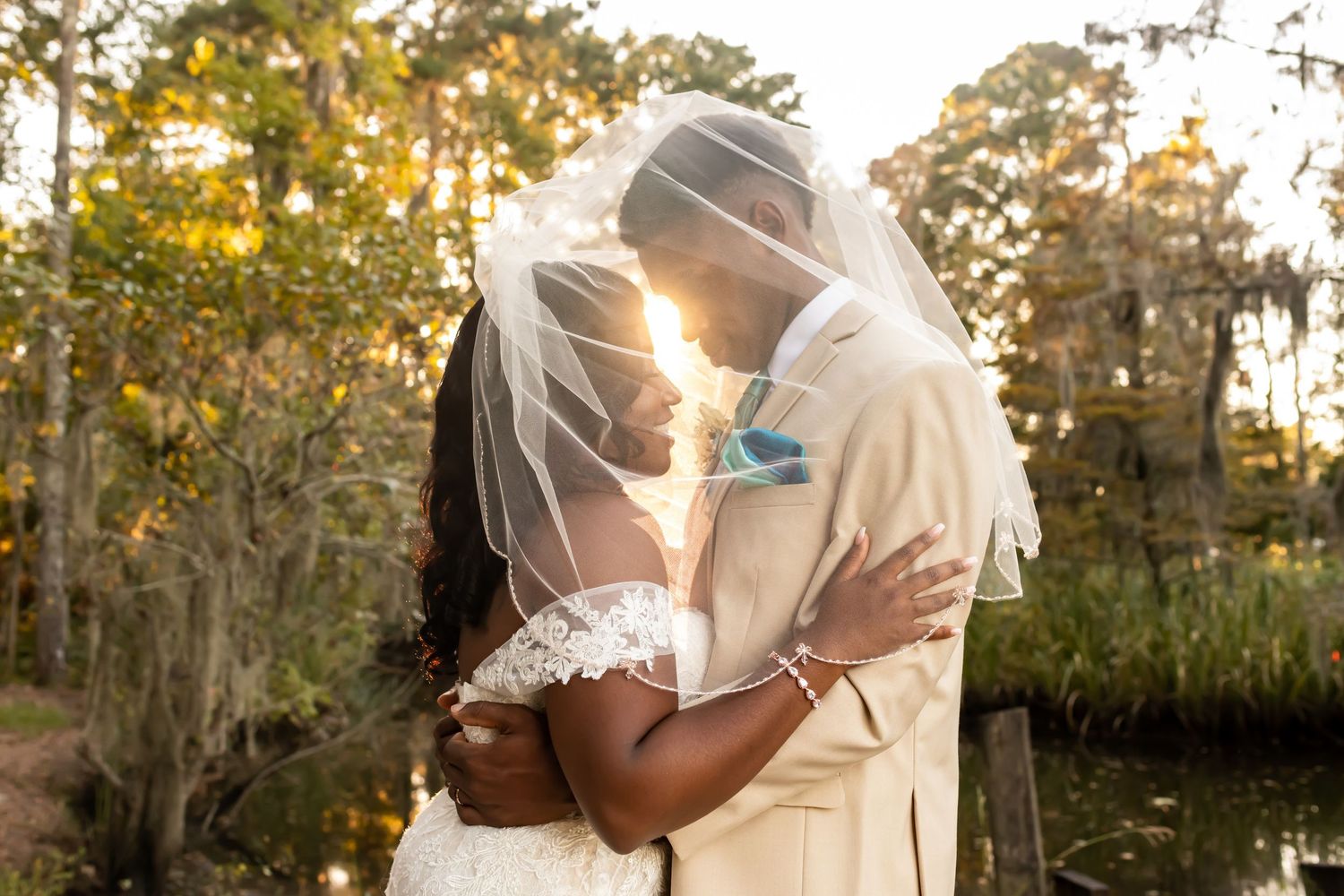 Sunlit garden scene with Spanish moss and trees creating romantic backdrop.