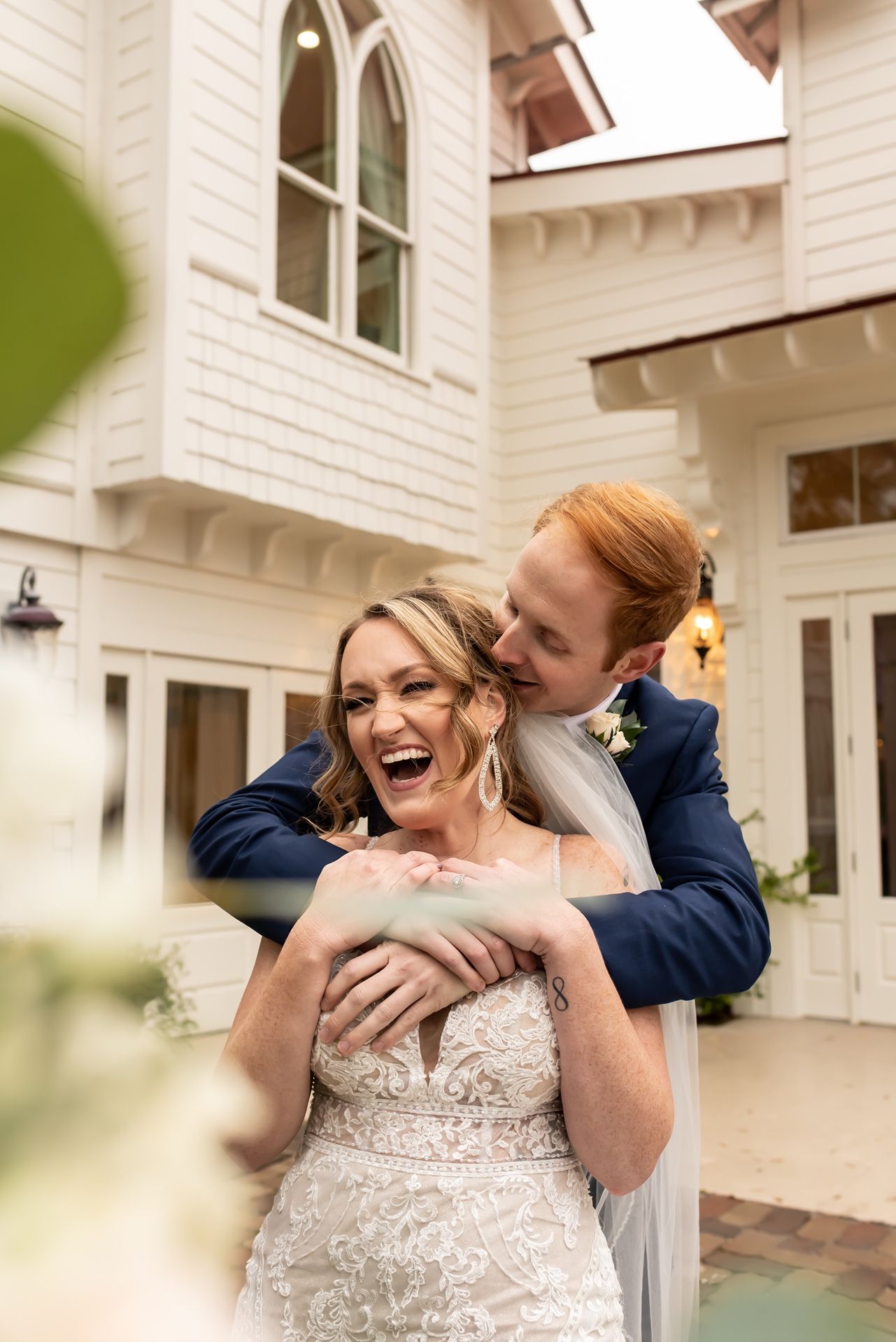 A romantic sequence of photos showing a bride and groom embracing on their wedding day in front of a white building.