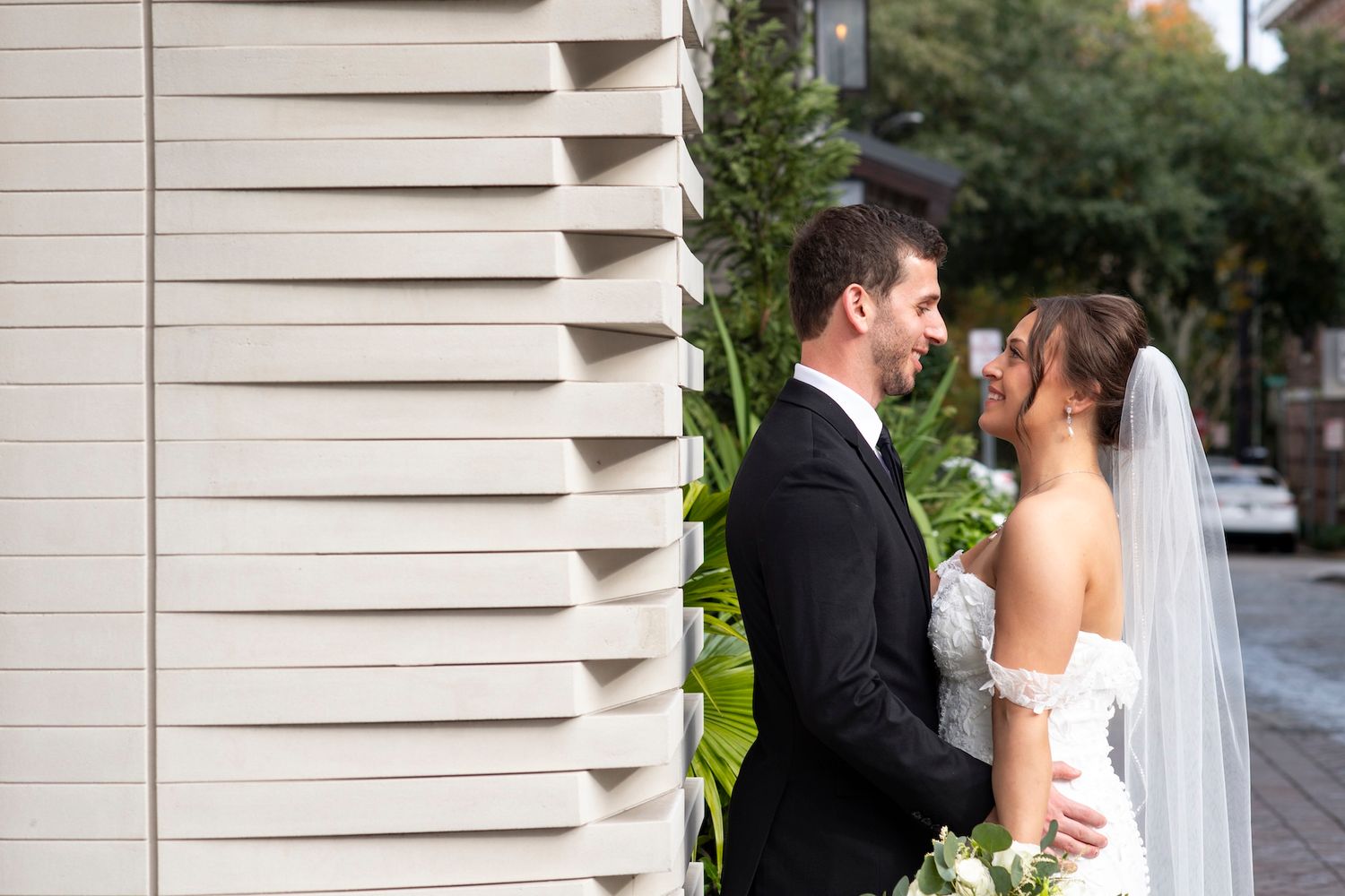 Bride and groom share romantic moments in a series of photos with white columns in the background.