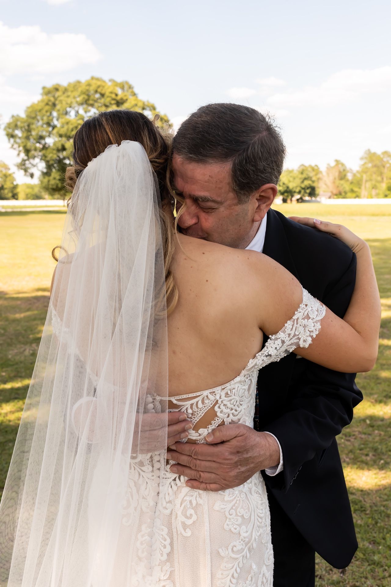 A series of intimate wedding photos shows tender embraces between a bride in a lace dress and groom in a dark suit outdoors.
