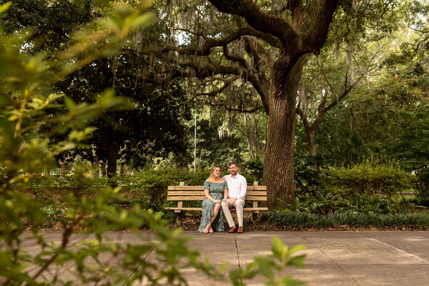 Couple sits on bench in Forsyth Park.