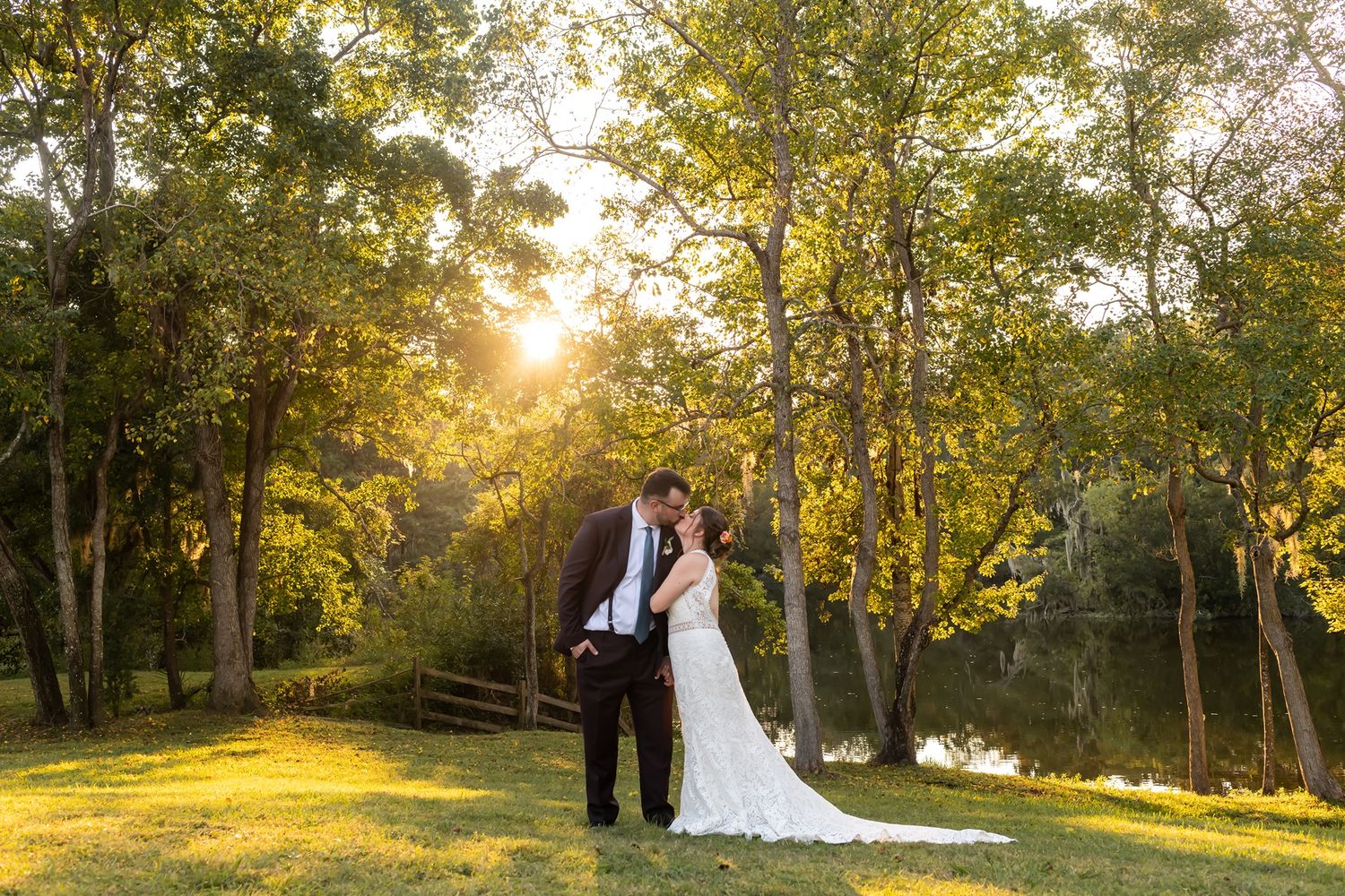 A sunset wedding photoshoot in a lush wooded park with golden sunlight filtering through the autumn trees.