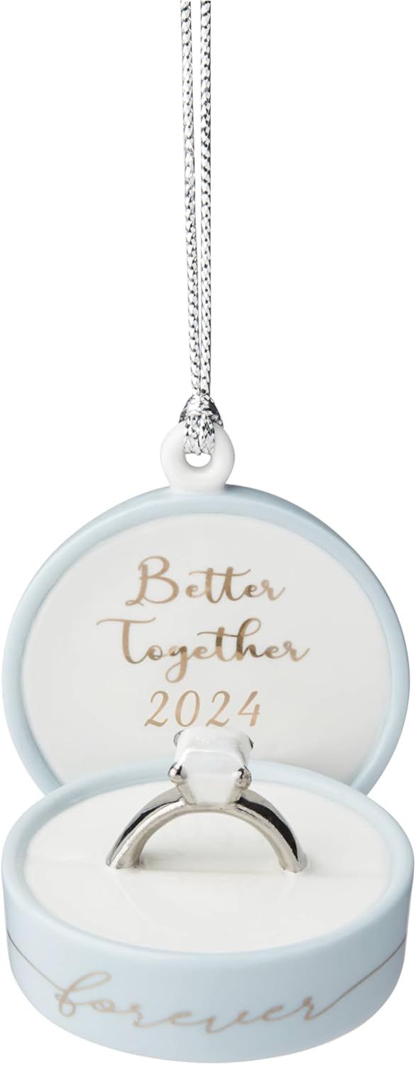 White ceramic ring holders with 'Better Together 2024' text in elegant gold script on display with silver chains.