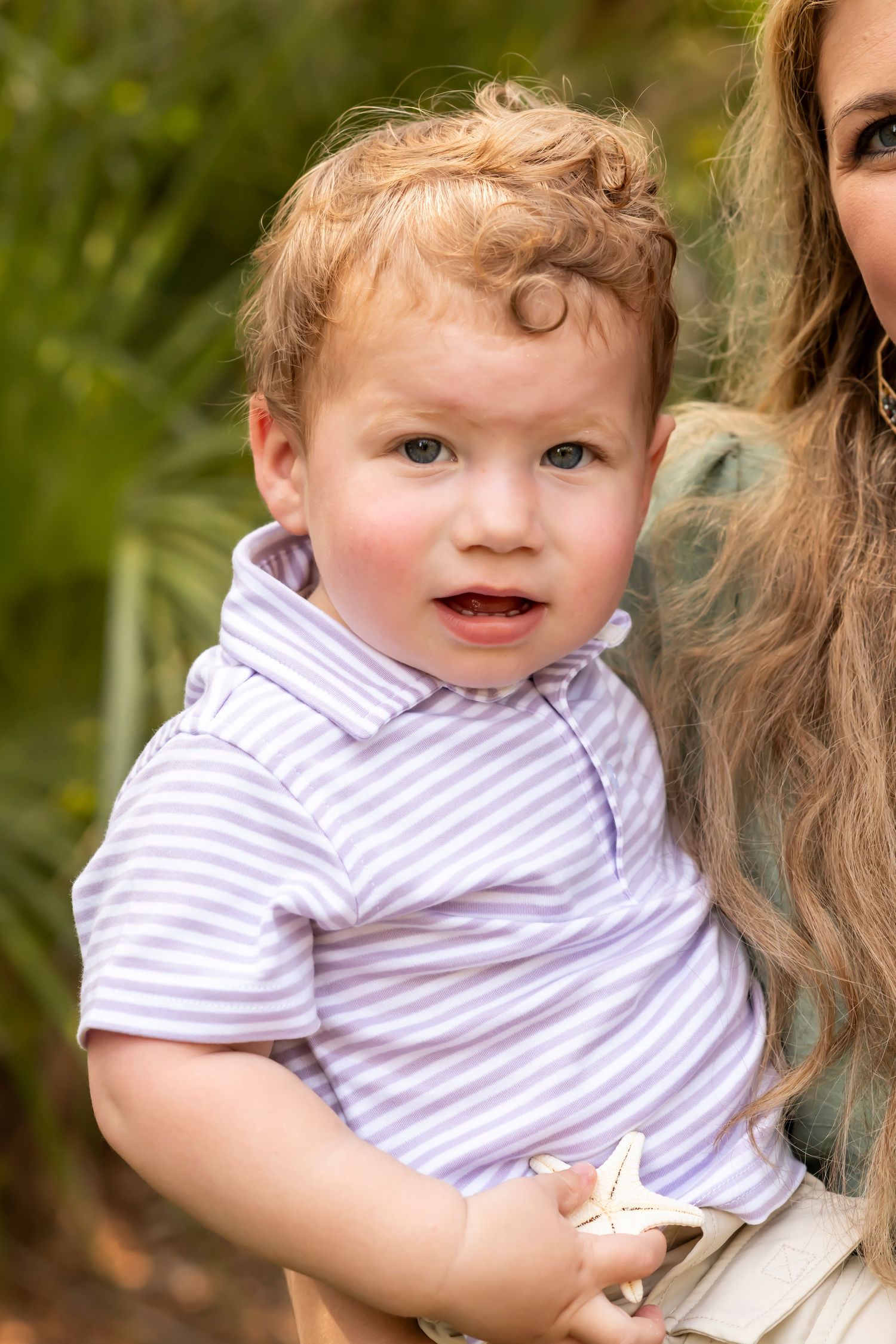 Collage of a smiling baby wearing a purple striped shirt while being held, shown from different angles outdoors.
