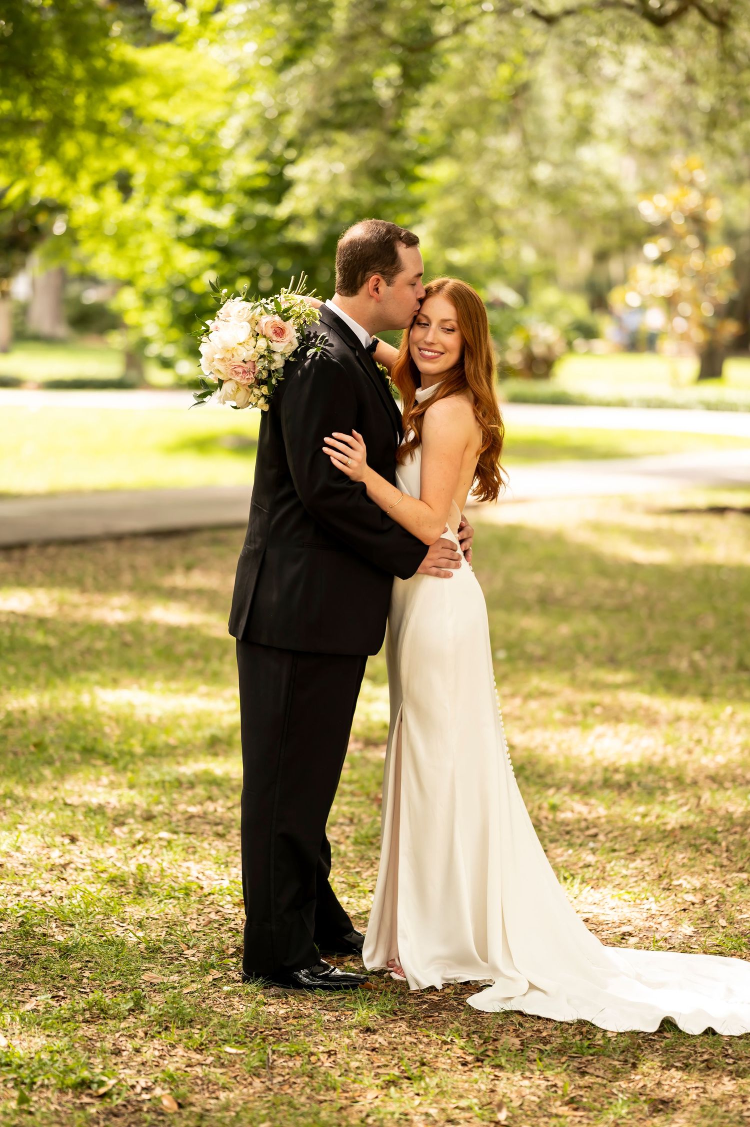 A romantic outdoor wedding photoshoot sequence showing a loving embrace between a couple in formal attire.