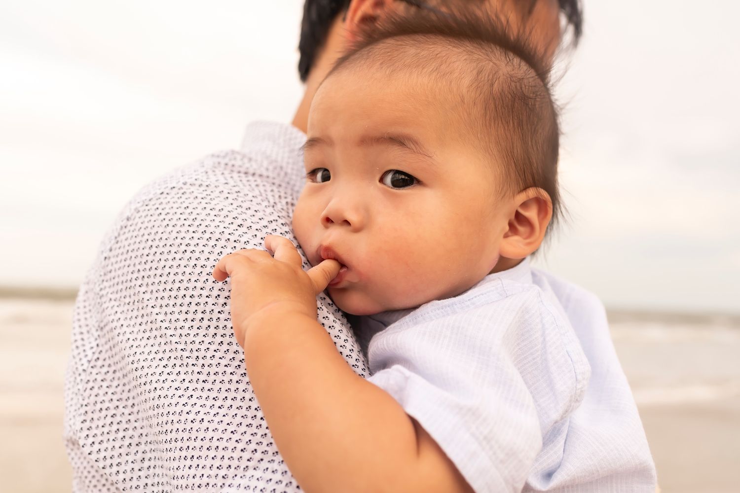 A series of three similar photos showing a baby drinking milk from a bottle against a light background.