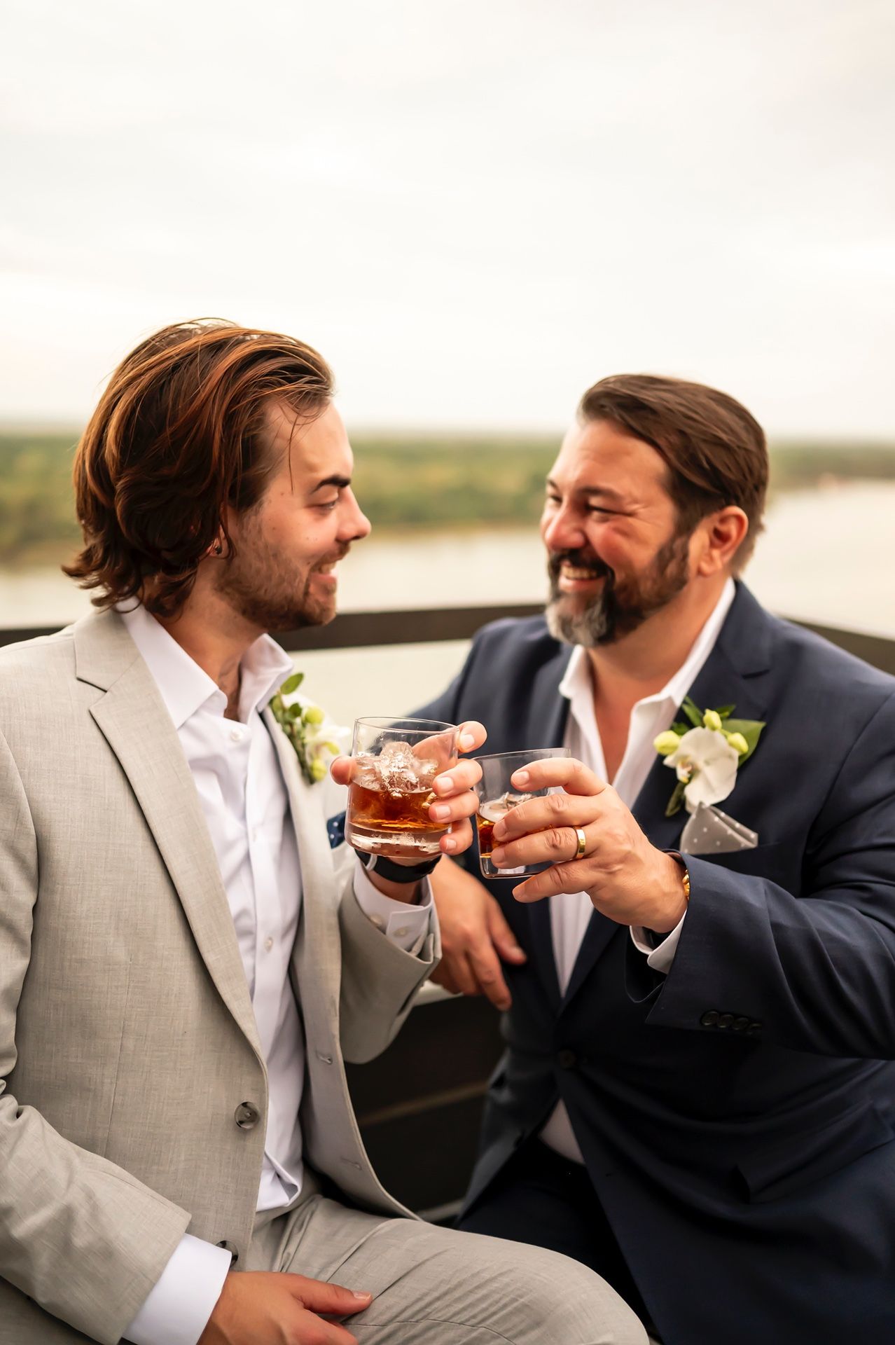 Two people in formal attire share drinks and conversation outdoors at sunset in a candid photo series.
