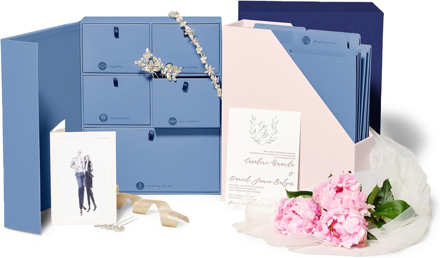 Elegant blue stationery set with file folders, note cards, floral decorations and blush pink carnations arranged together.