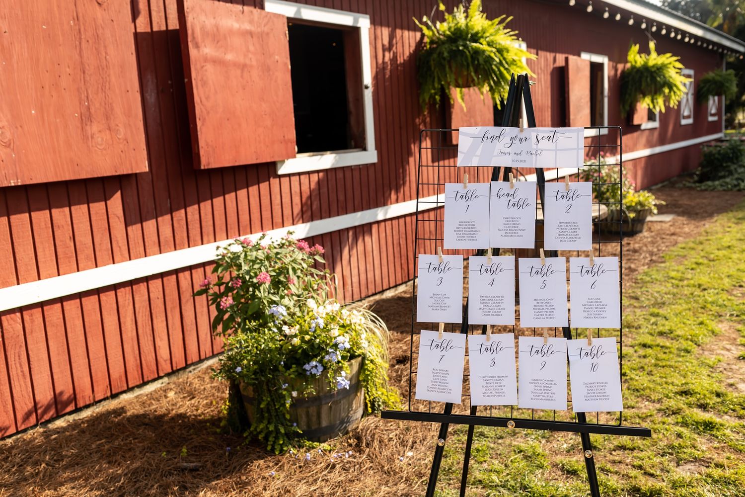 A sequence of outdoor notice boards mounted with white papers displayed along a wooden building exterior.
