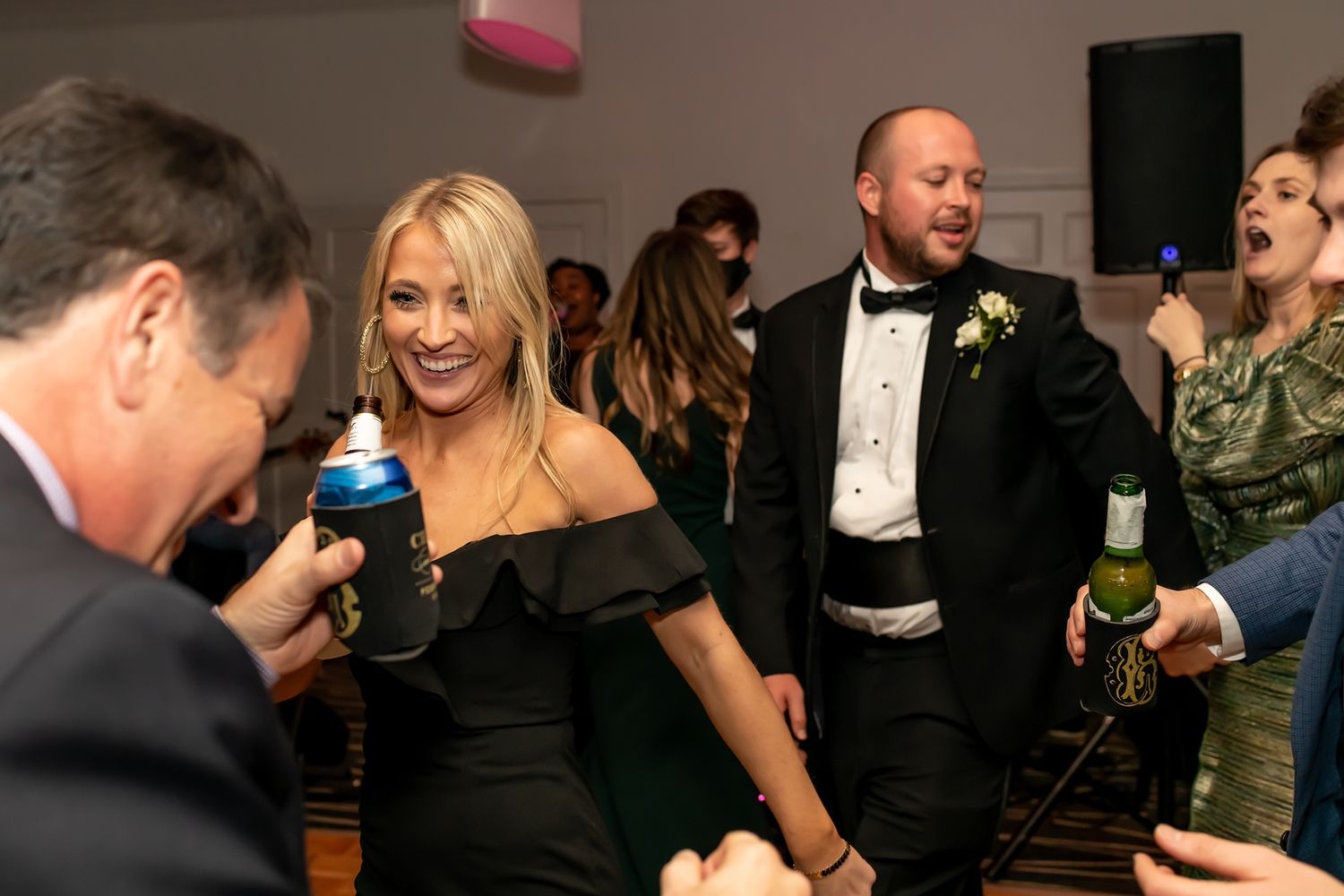 Party guests in formal attire enjoying drinks and conversation at an elegant evening event.
