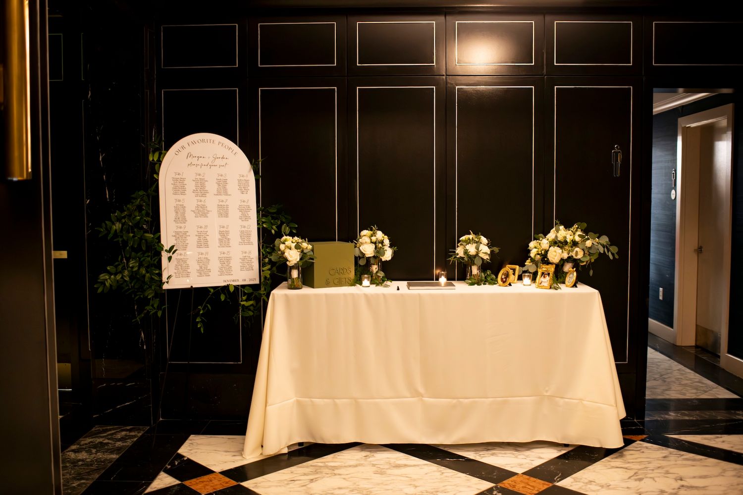 Elegant wedding reception tables adorned with white linens and candlelight create a romantic atmosphere.