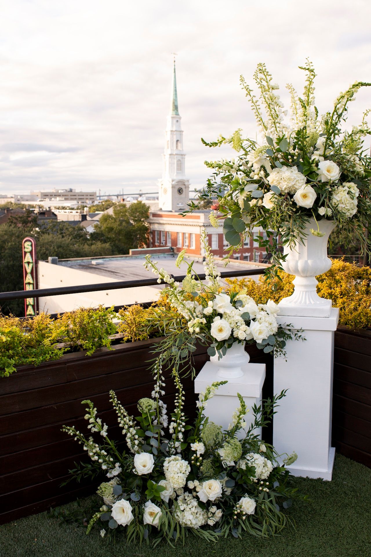 Green, white, and gold ceremony details at Perry Lane Hotel rooftop wedding ceremony in Savannah, Georgia.