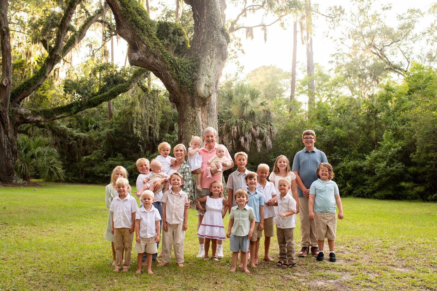 Grandparents surrounded by their grandchildren during an extended family session in Sea Pines.