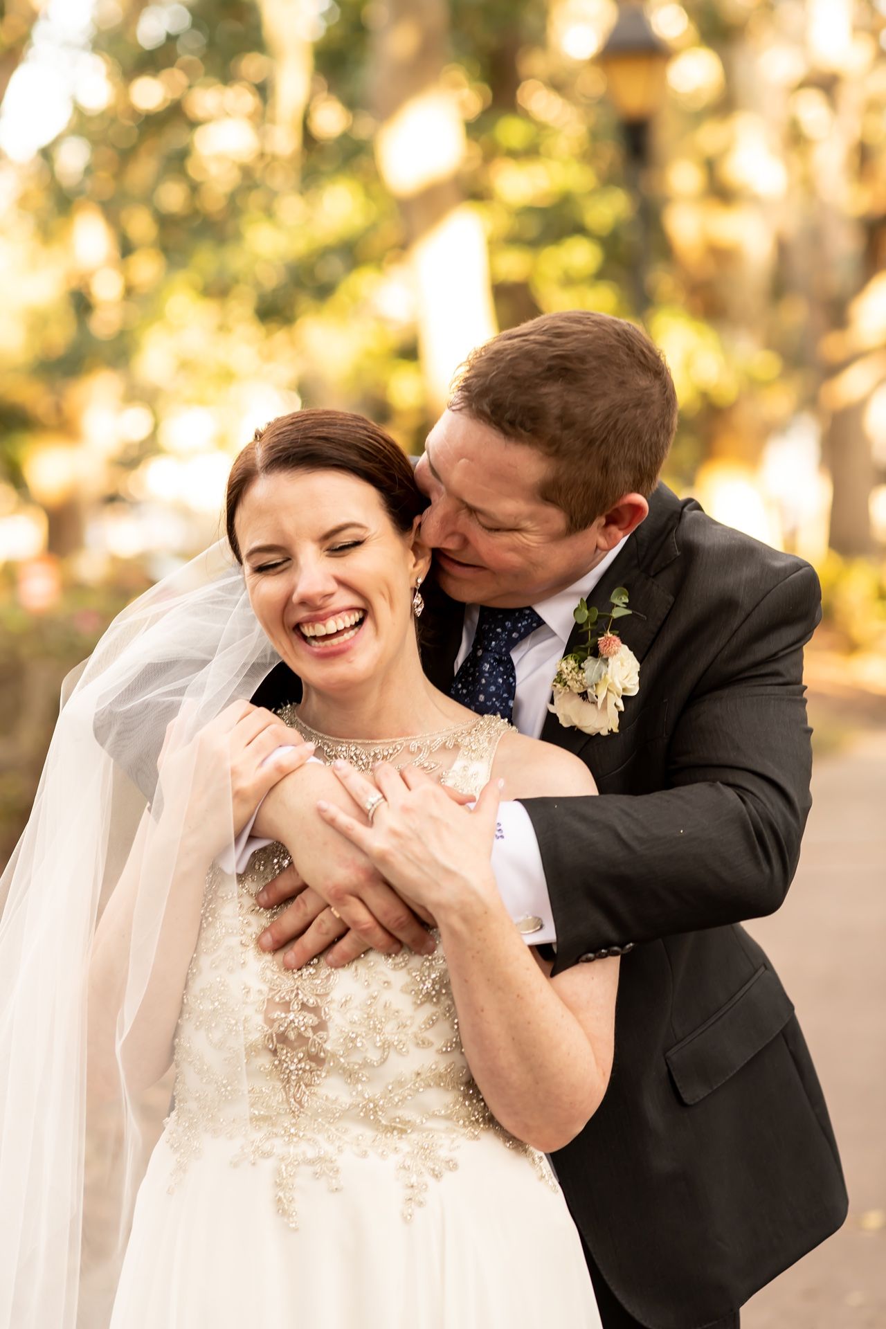 Happy wedding couple shares intimate embraces in a romantic outdoor setting with golden sunlight.