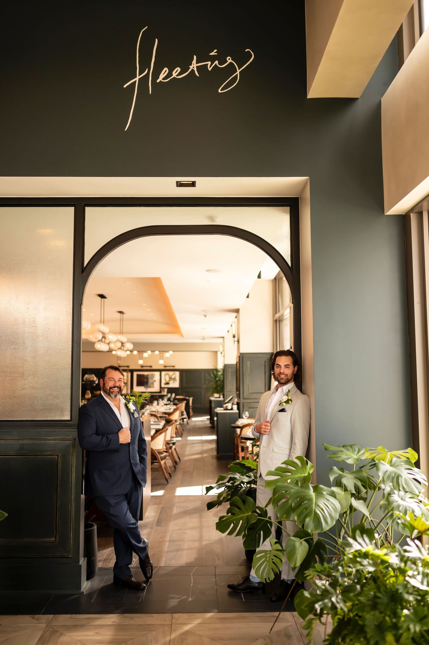 Grooms pose for a portrait outside Fleeting restaurant for their Thompson Savannah wedding.