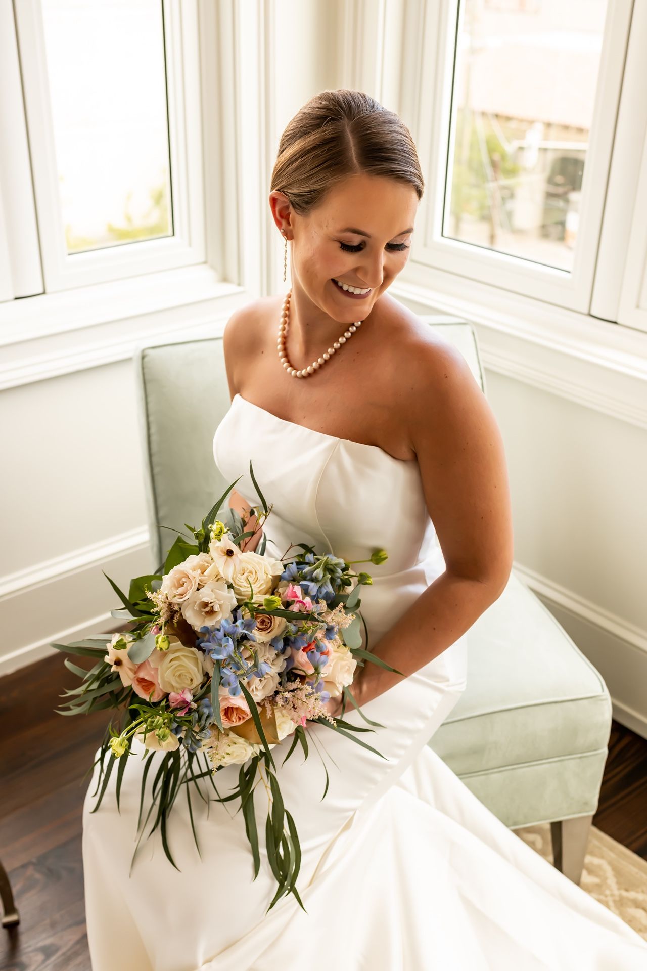 A series of cropped bridal portraits showing a white wedding gown and delicate pastel floral bouquet near sunlit windows.